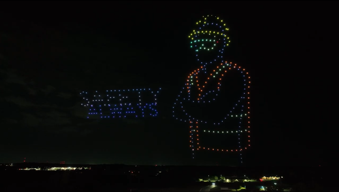An image from an NLDS drone show depicting a construction worker with the company's tagline: Safety Always.