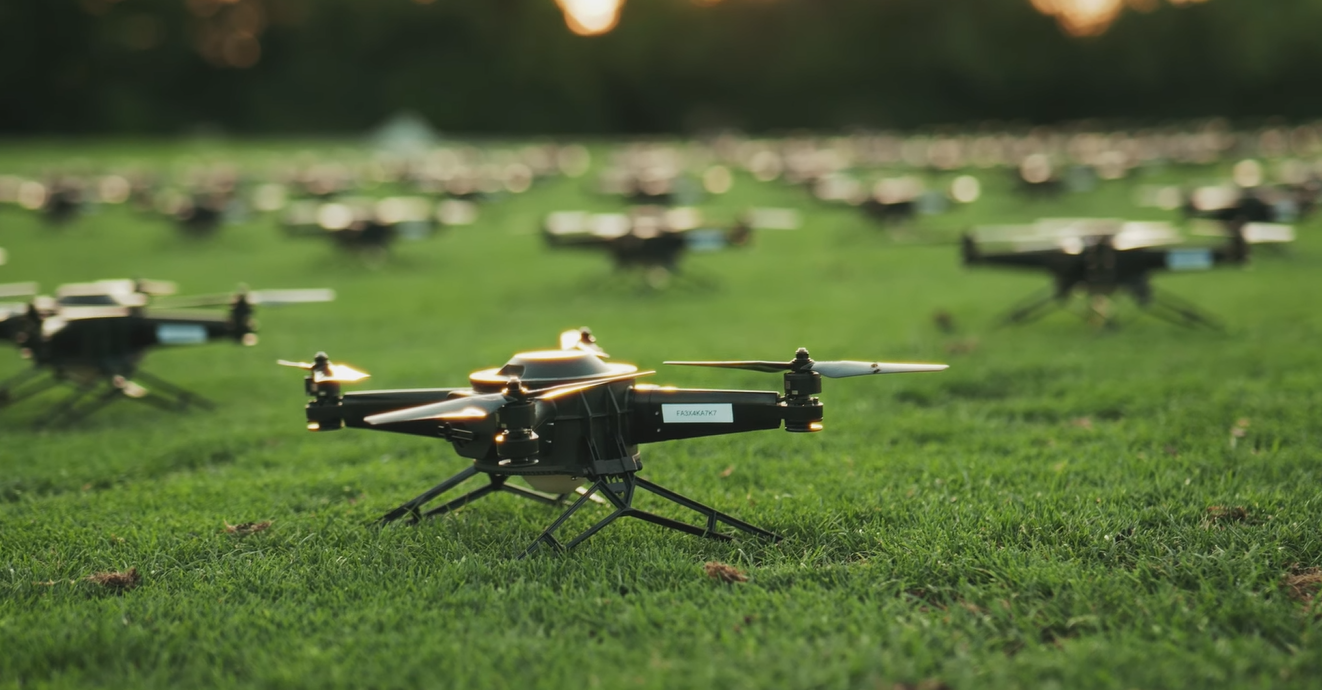 Hundreds of NLDS drones arranged on grass while the pilots ready them for takeoff.