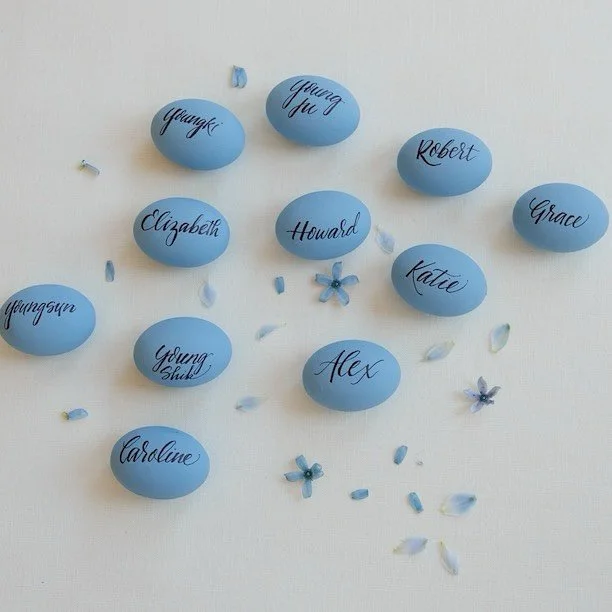 Our couple met at church on Easter.  We knew we had to weave this meaningful detail into their wedding day. Hand-calligraphed eggs became the sweetest nod to their story&mdash;swipe to see how they doubled as charming place cards at the reception.
 
