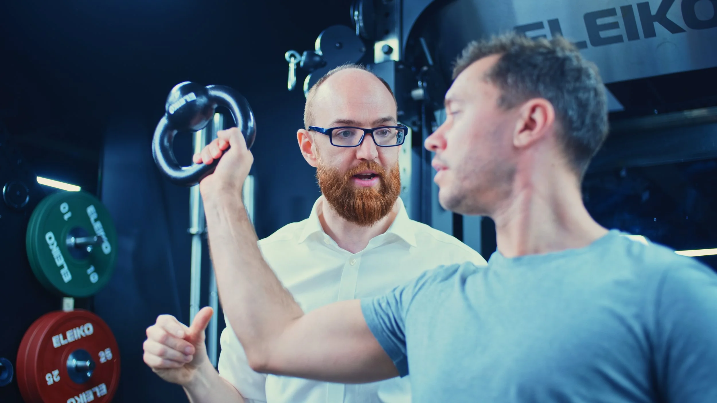 Patient performing post-operative shoulder rehabilitation following subacromial decompression surgery with guidance from a sports rehabilitation specialist to restore strength, mobility and function.