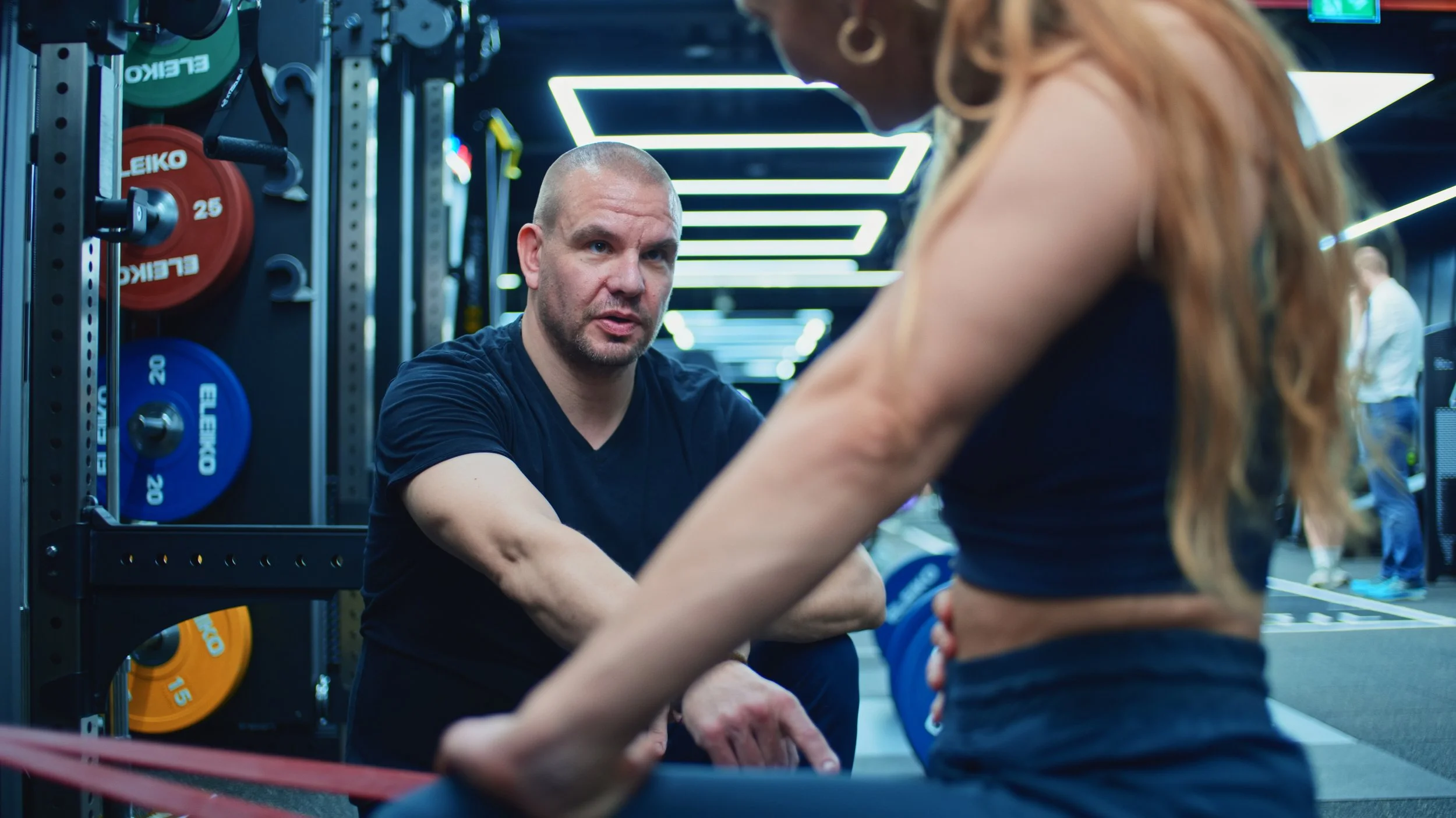 A personal trainer works with a patient to strengthen their hamstring