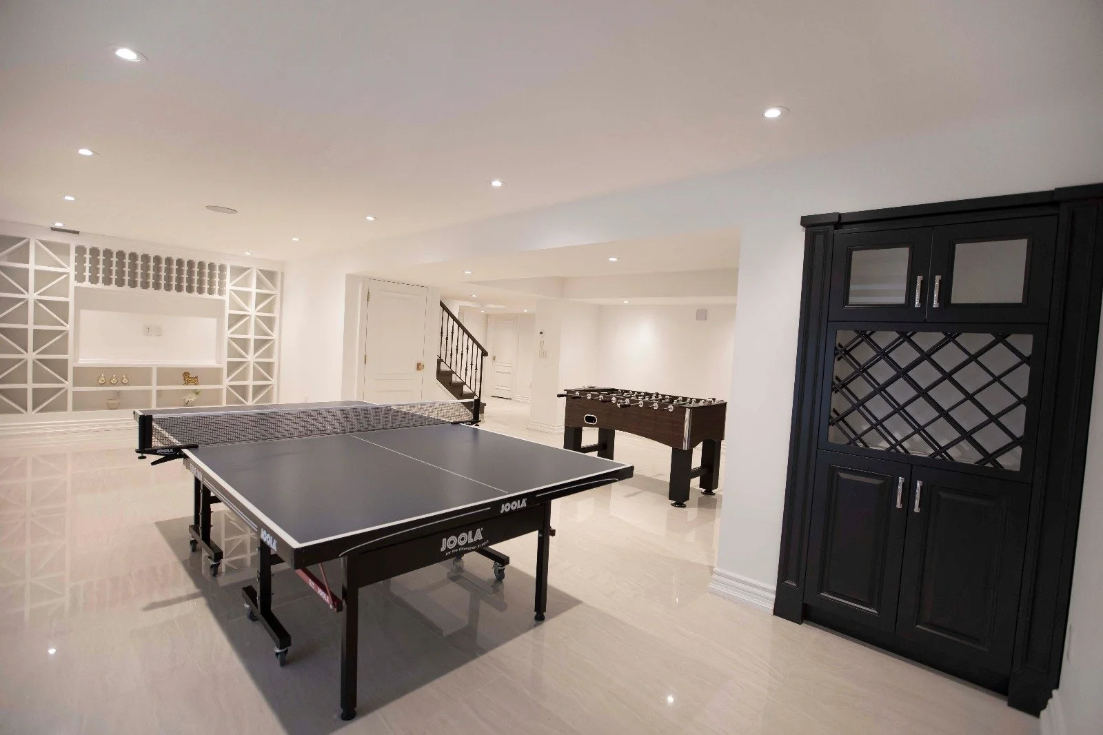 Dynamic game room by Summit-X, complete with a ping-pong table, foosball, and vibrant decor for endless entertainment.
