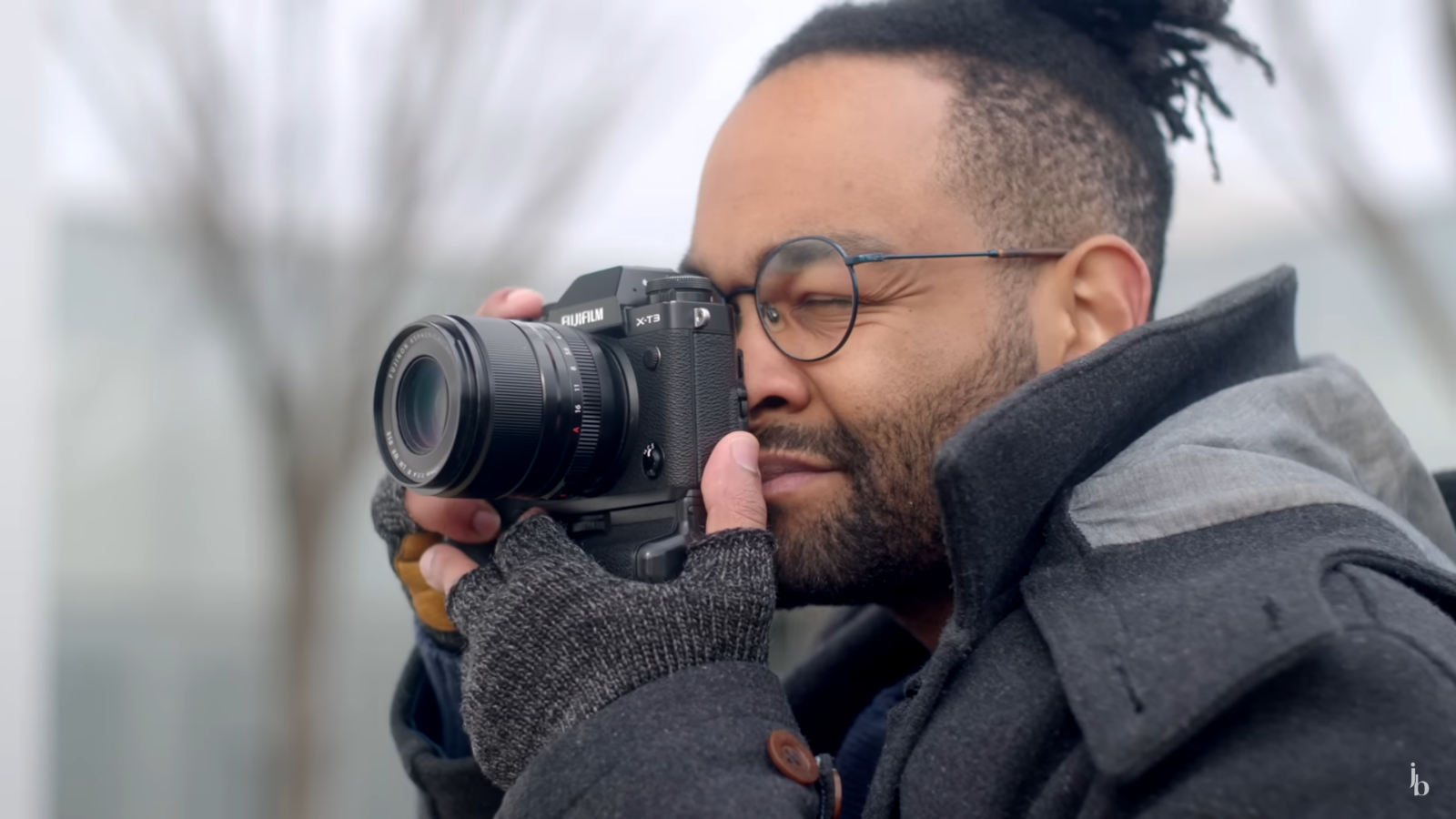 John Branch practicing street photography with a Fujifilm camera outdoors.