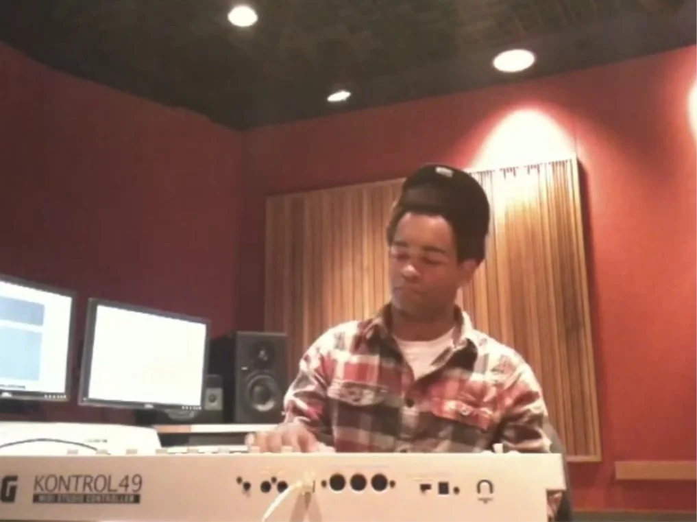 John Branch playing a keyboard in a recording studio early in his creative career.