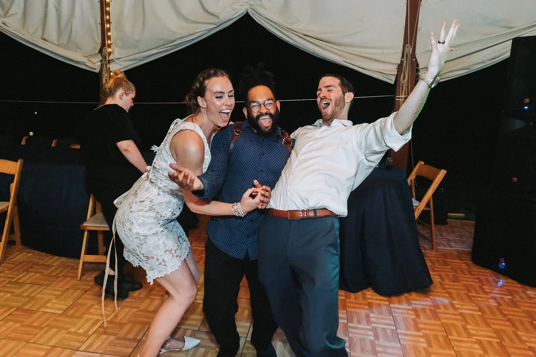 John Branch IV Wedding Photographer celebrating with a happy bride and groom at their reception.
