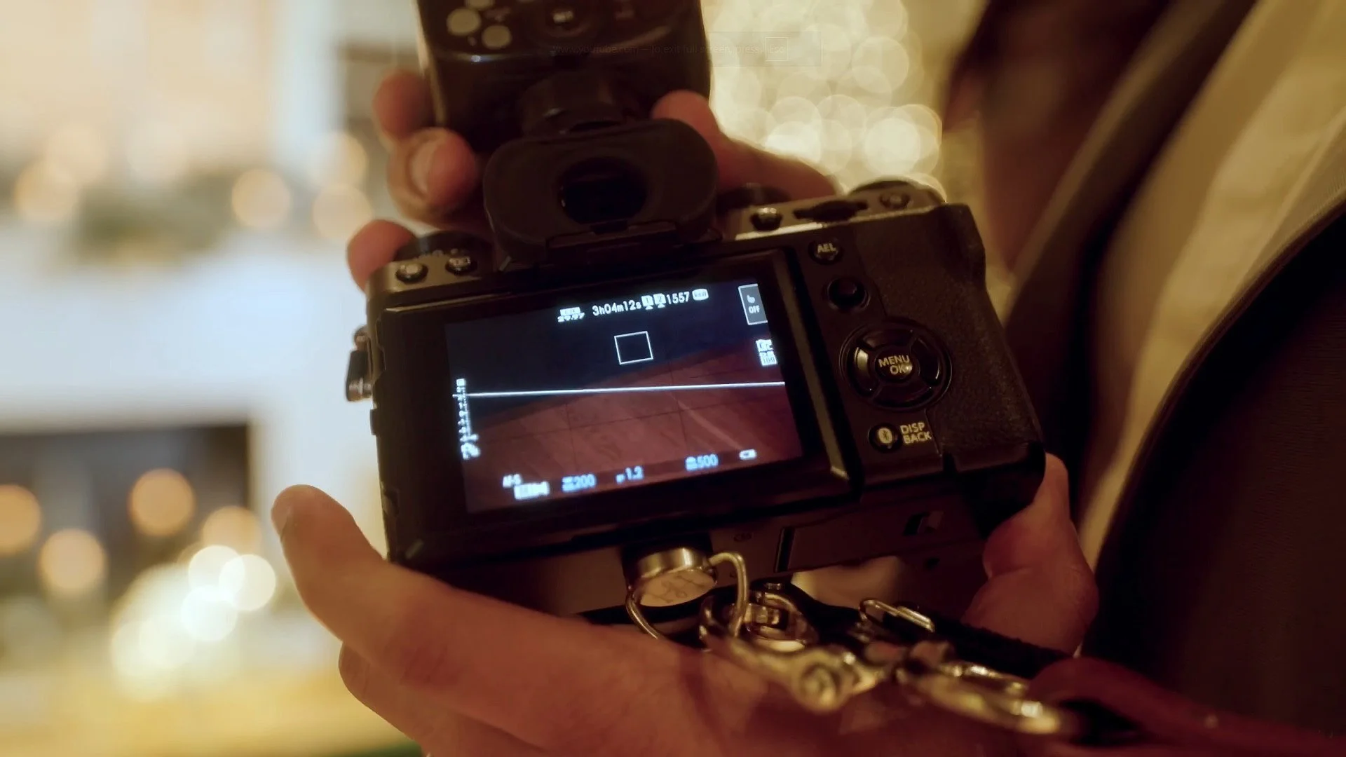 Back view of Fujifilm X-T5 showing camera settings screen during wedding.