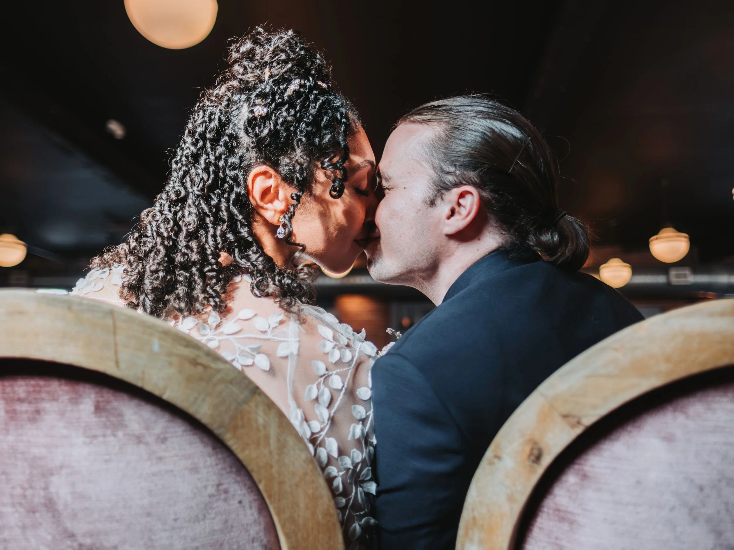 Bride and groom share their first kiss after the wedding ceremony.