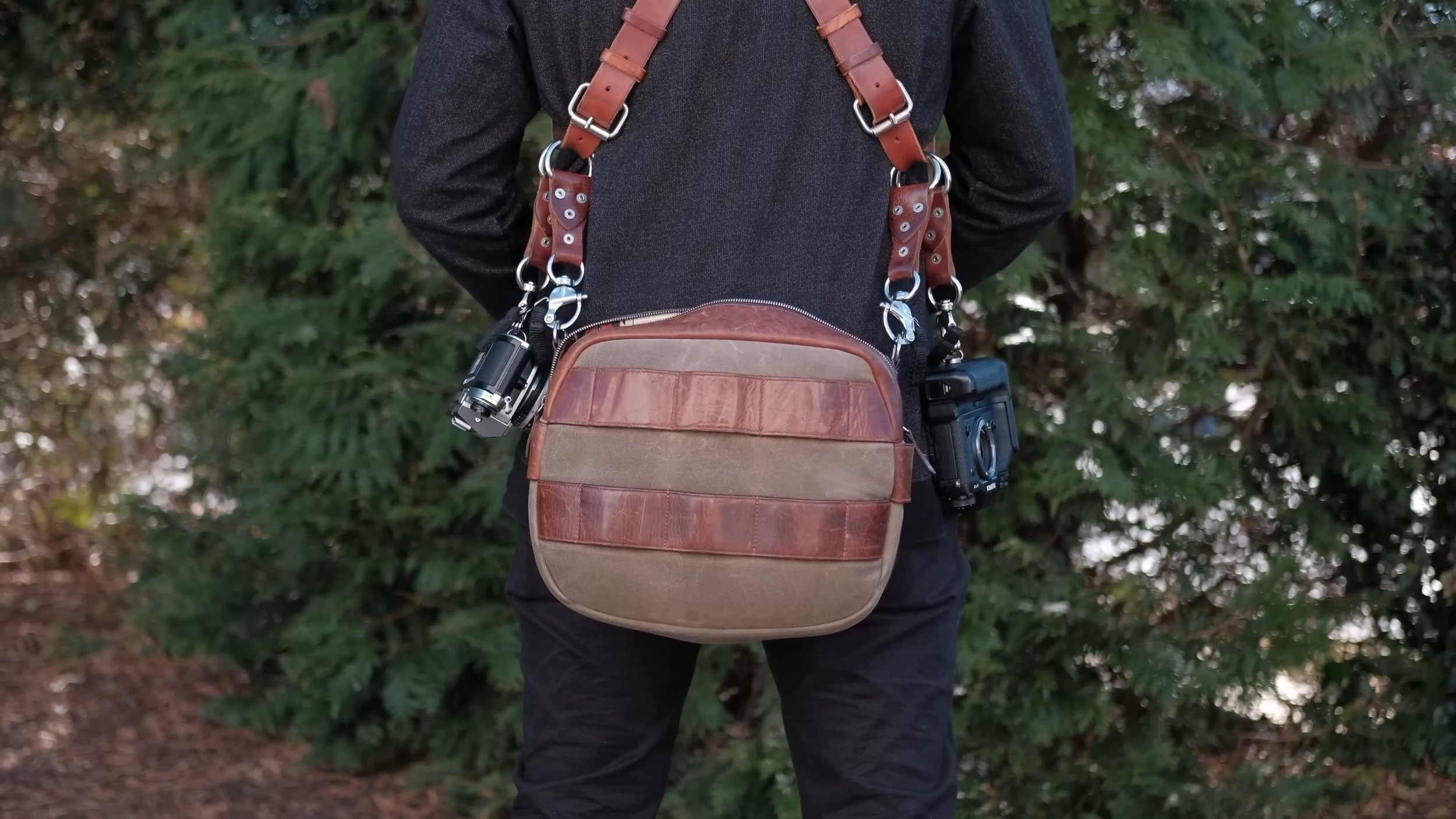 Leather camera harness and bag for wedding photography gear.