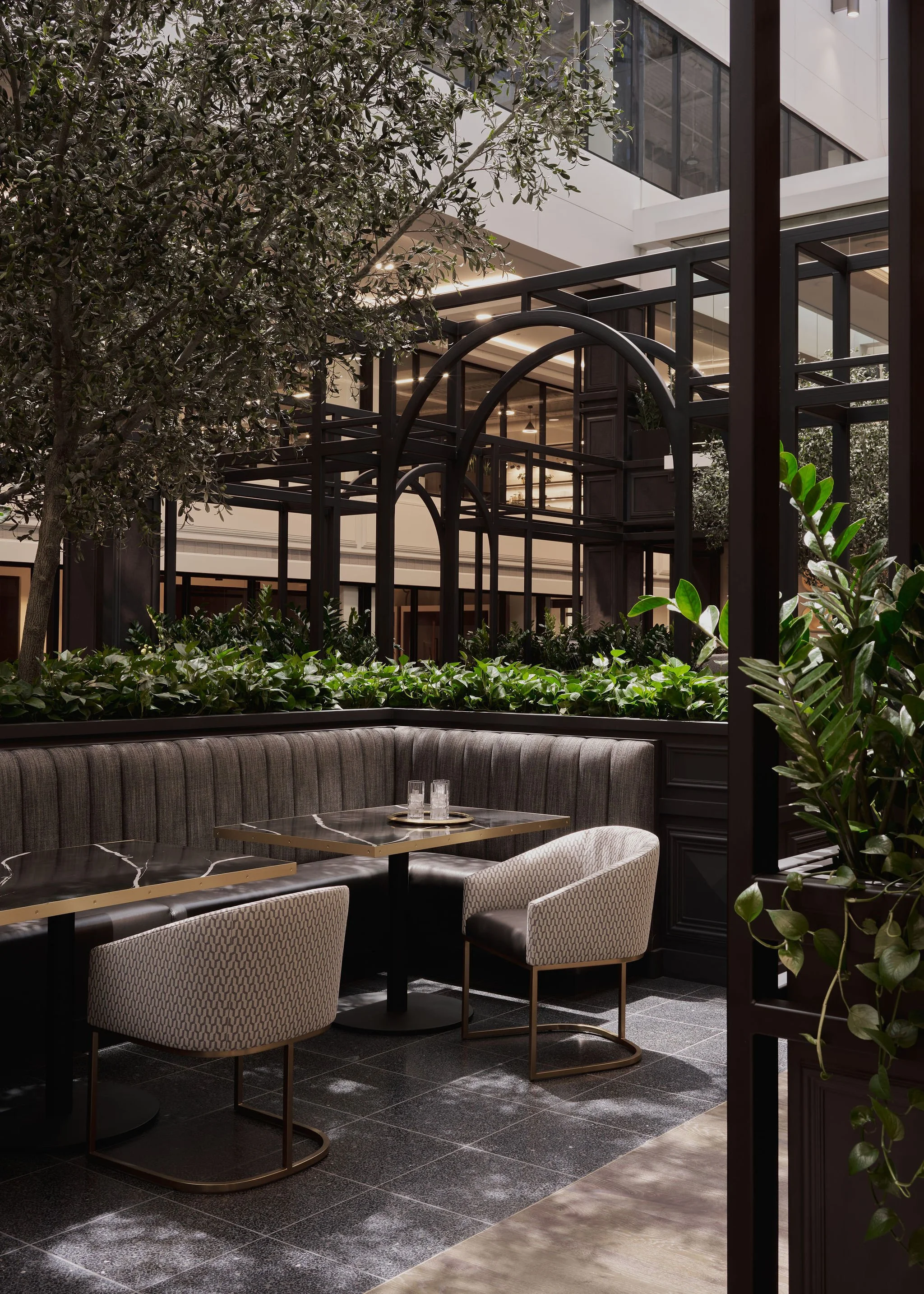 sitting area covered in live plants in commercial office building 