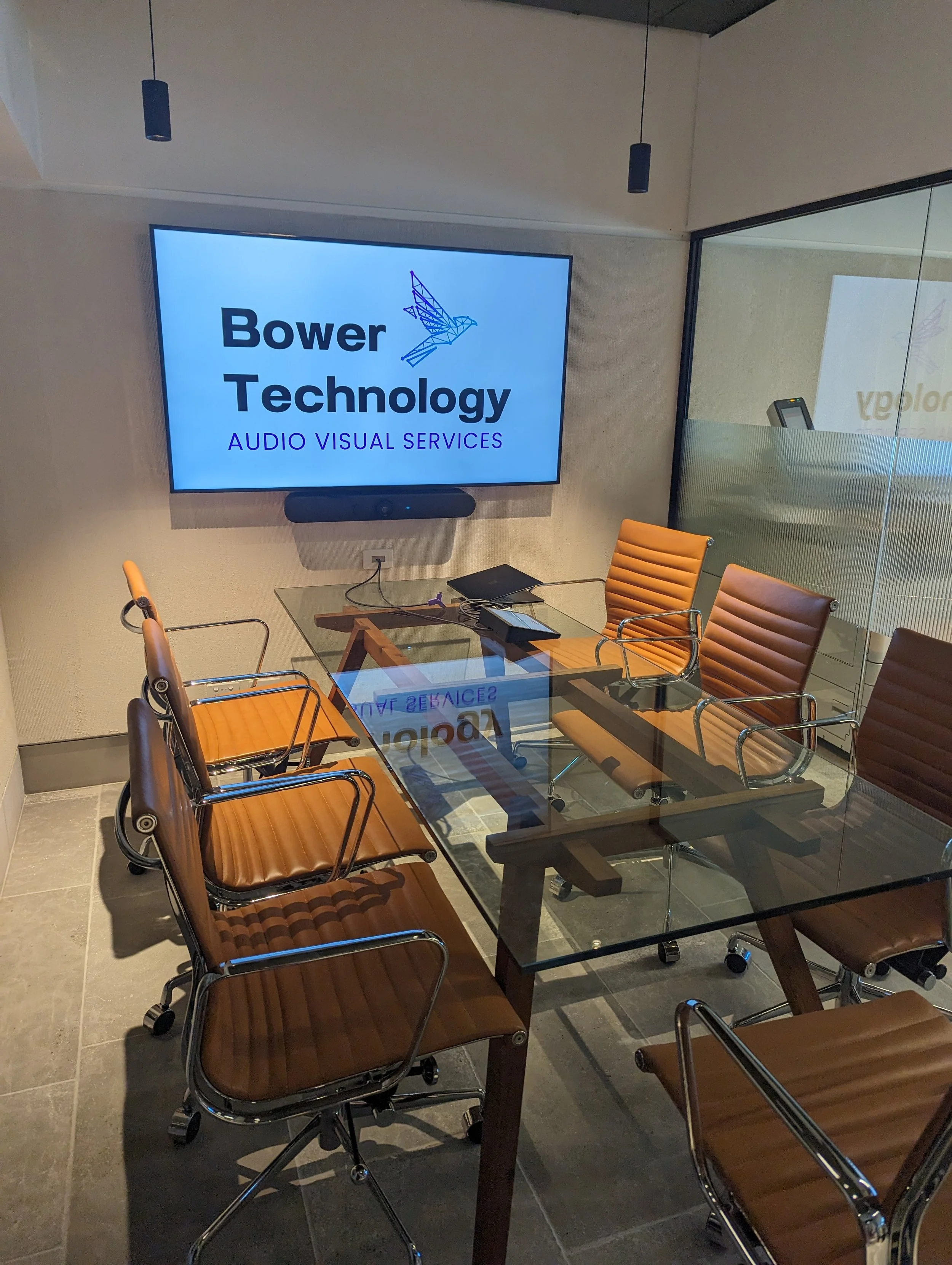 Corporate boardroom with Zoom Rooms conferencing system and BYOD conferencing with Logitech Rally