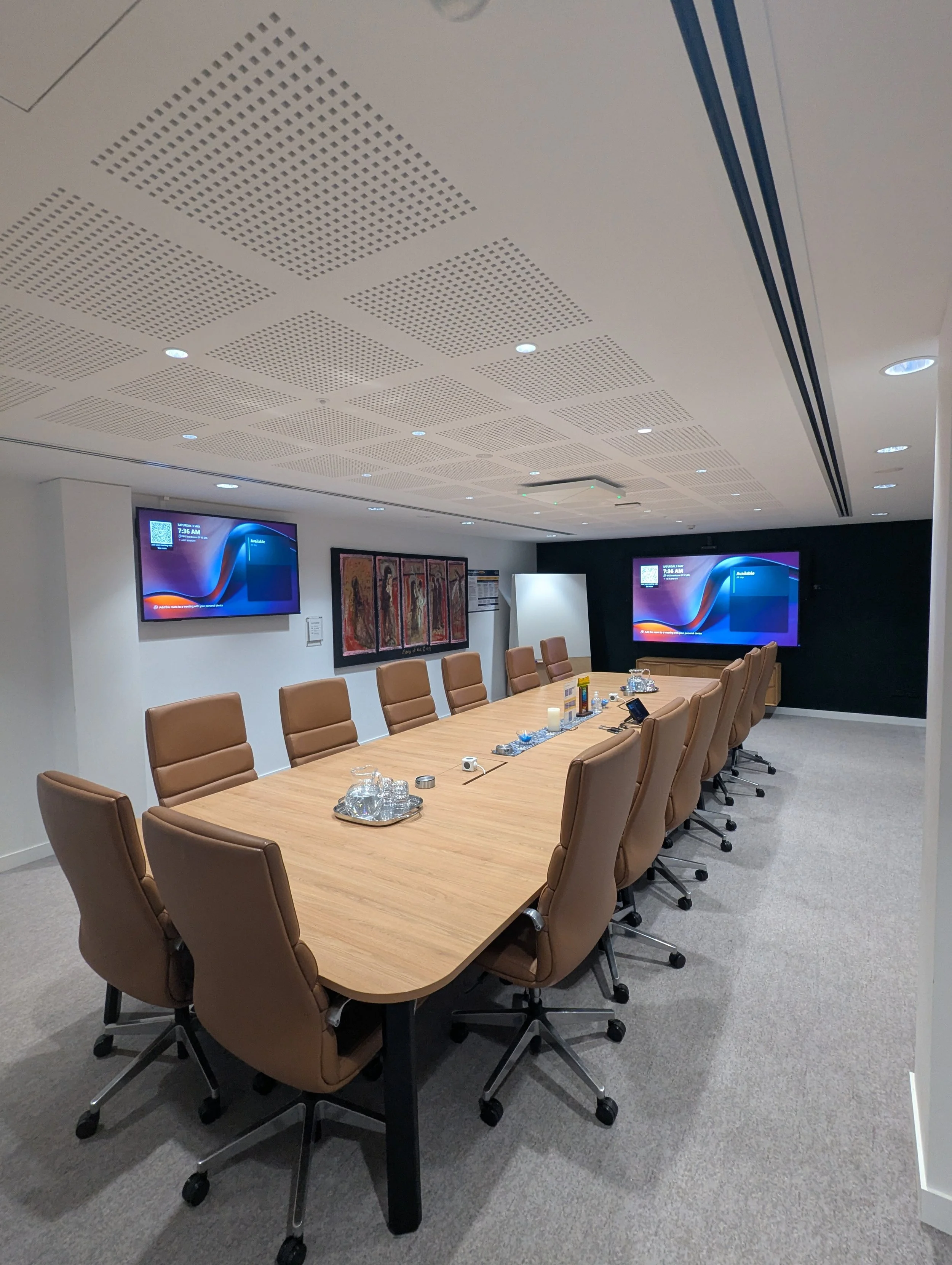 Meeting room with wall-mounted display and AV control integration.