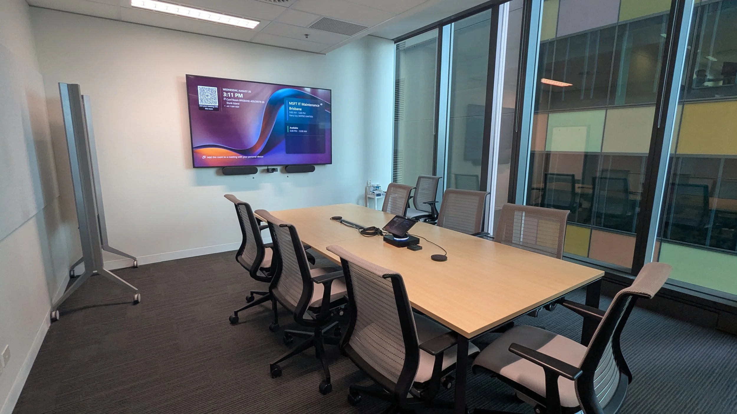 Corporate boardroom with Microsoft Teams Rooms conferencing system and commercial display installation