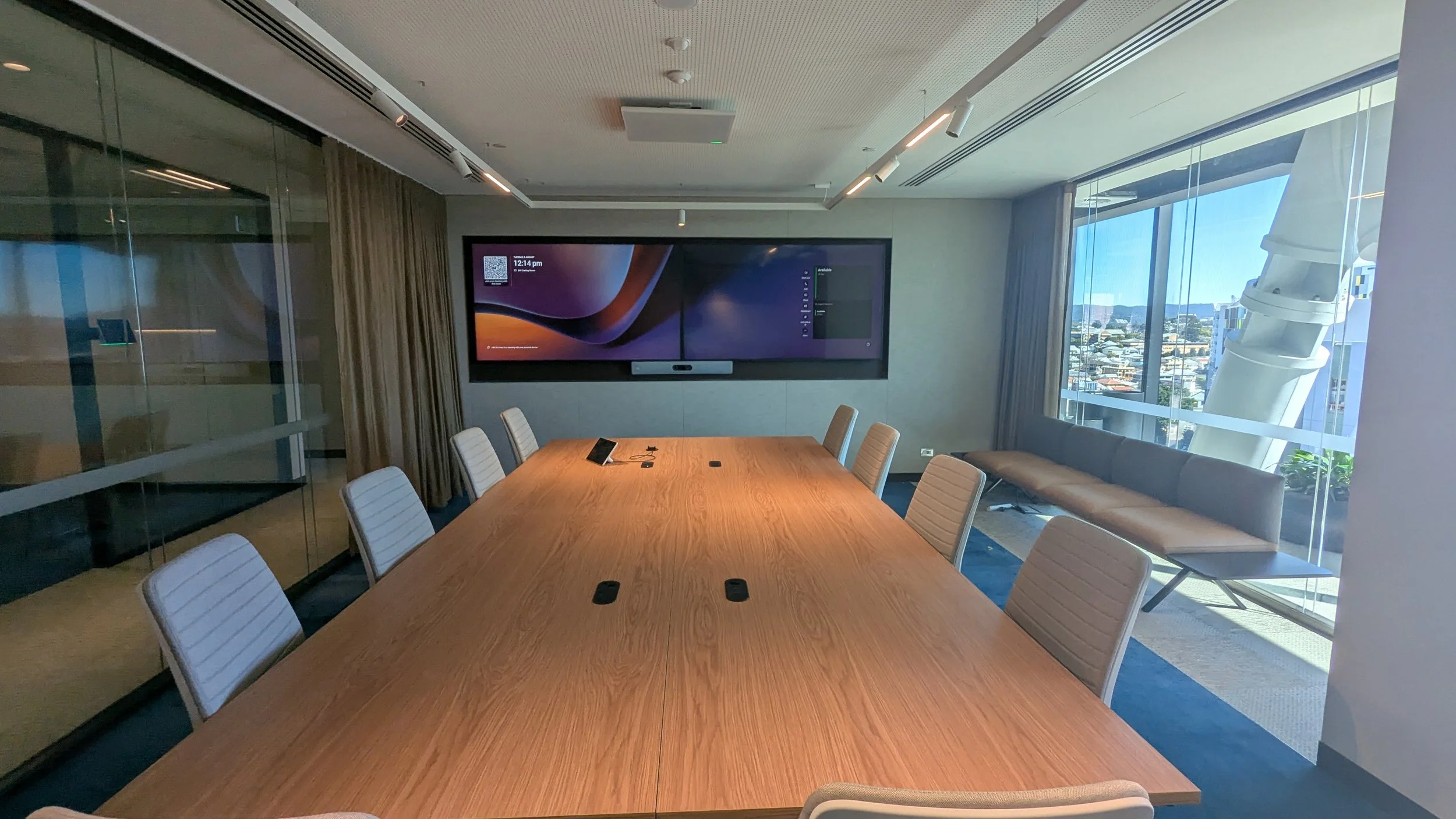 Corporate boardroom with Microsoft Teams Rooms conferencing system and dual screen commercial displays, QSYS and Shure audio and Cisco VC
