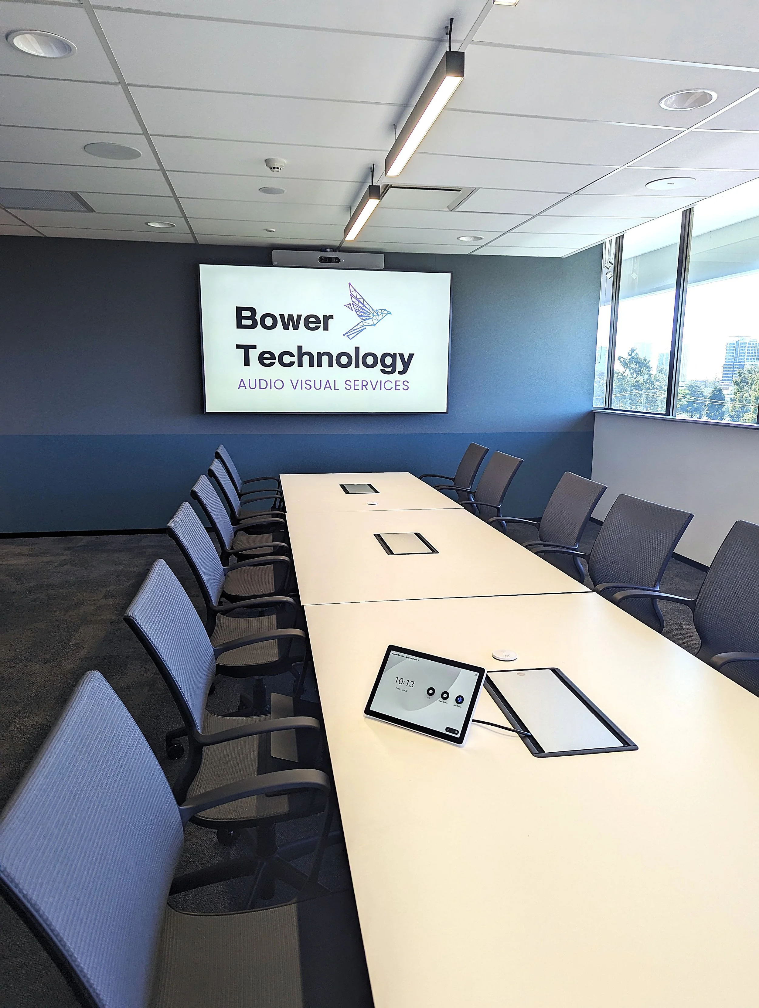 Corporate boardroom with Cisco Webex conferencing system: Codec EQ and Quad Camera, with Cisco Table Microphones and Cisco Navigator