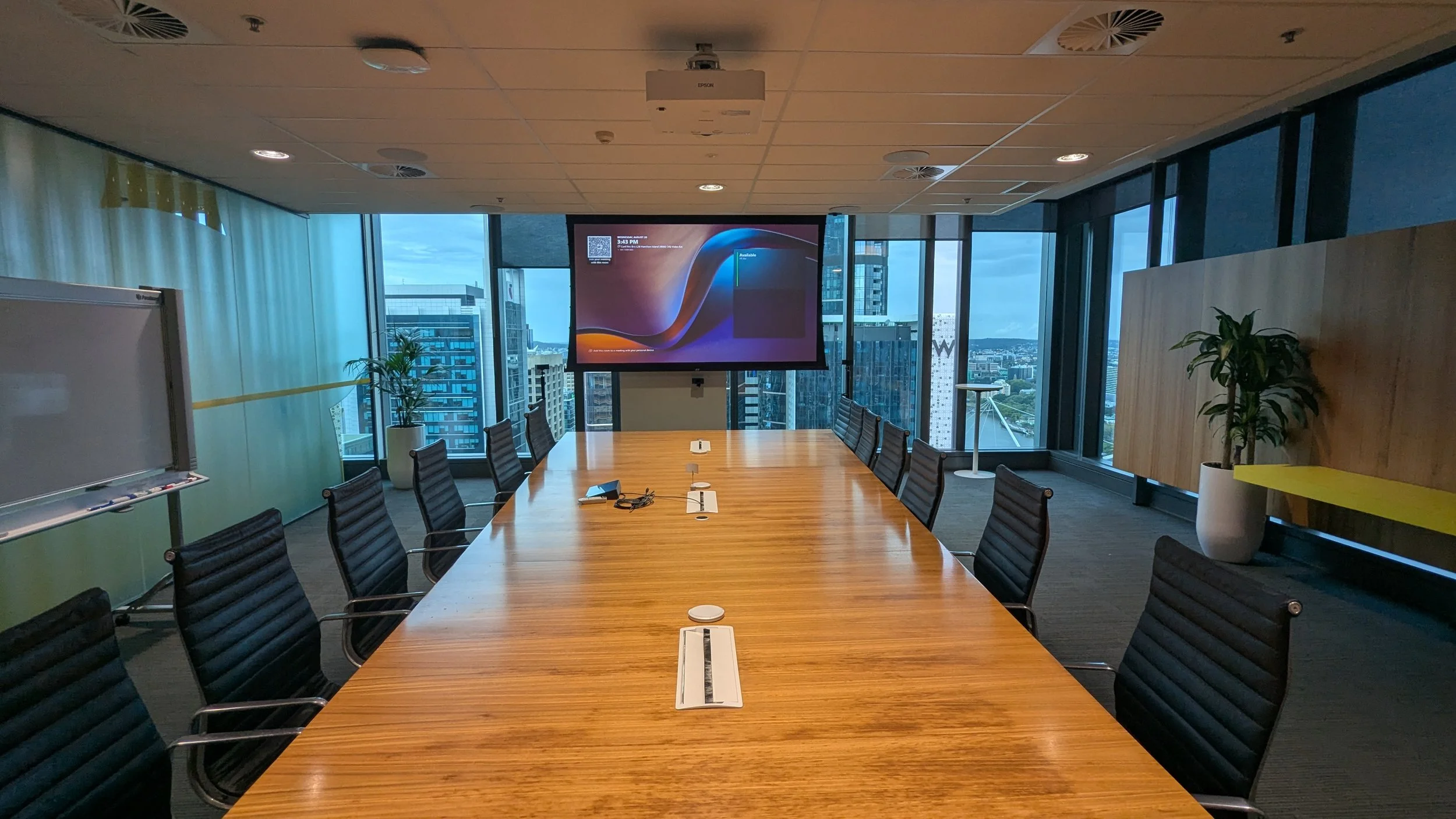 Corporate boardroom with Microsoft Teams Rooms conferencing system and projector installation