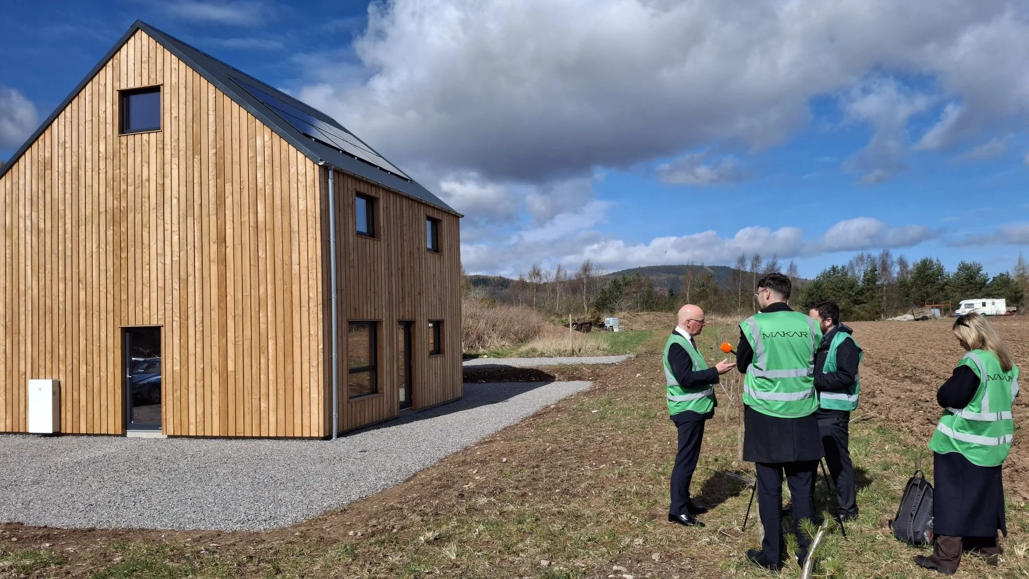  Swinney being interviewed in front of MAKAR’s prototype affordable home (Paradigm Home) 