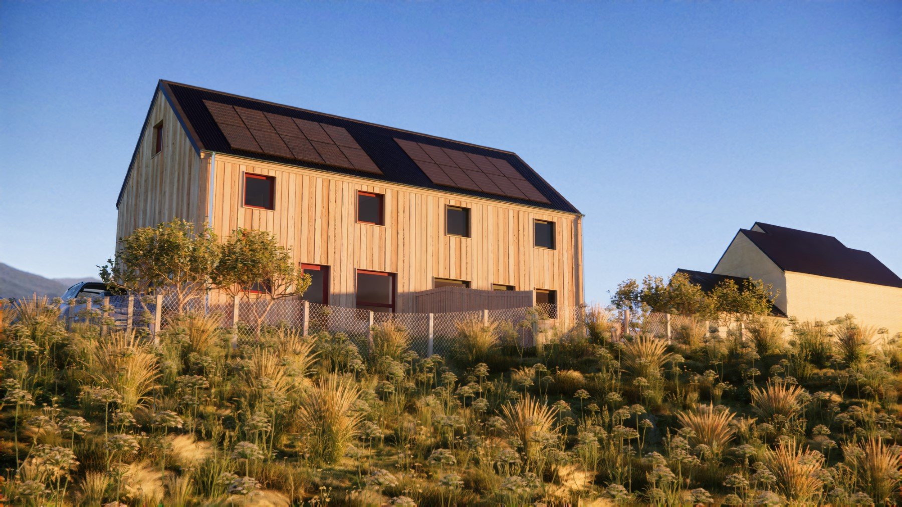 A timber semi-detached MAKAR house design with solar panels on the roof, surrounded by a garden with grasses and bushes, under a clear blue sky.