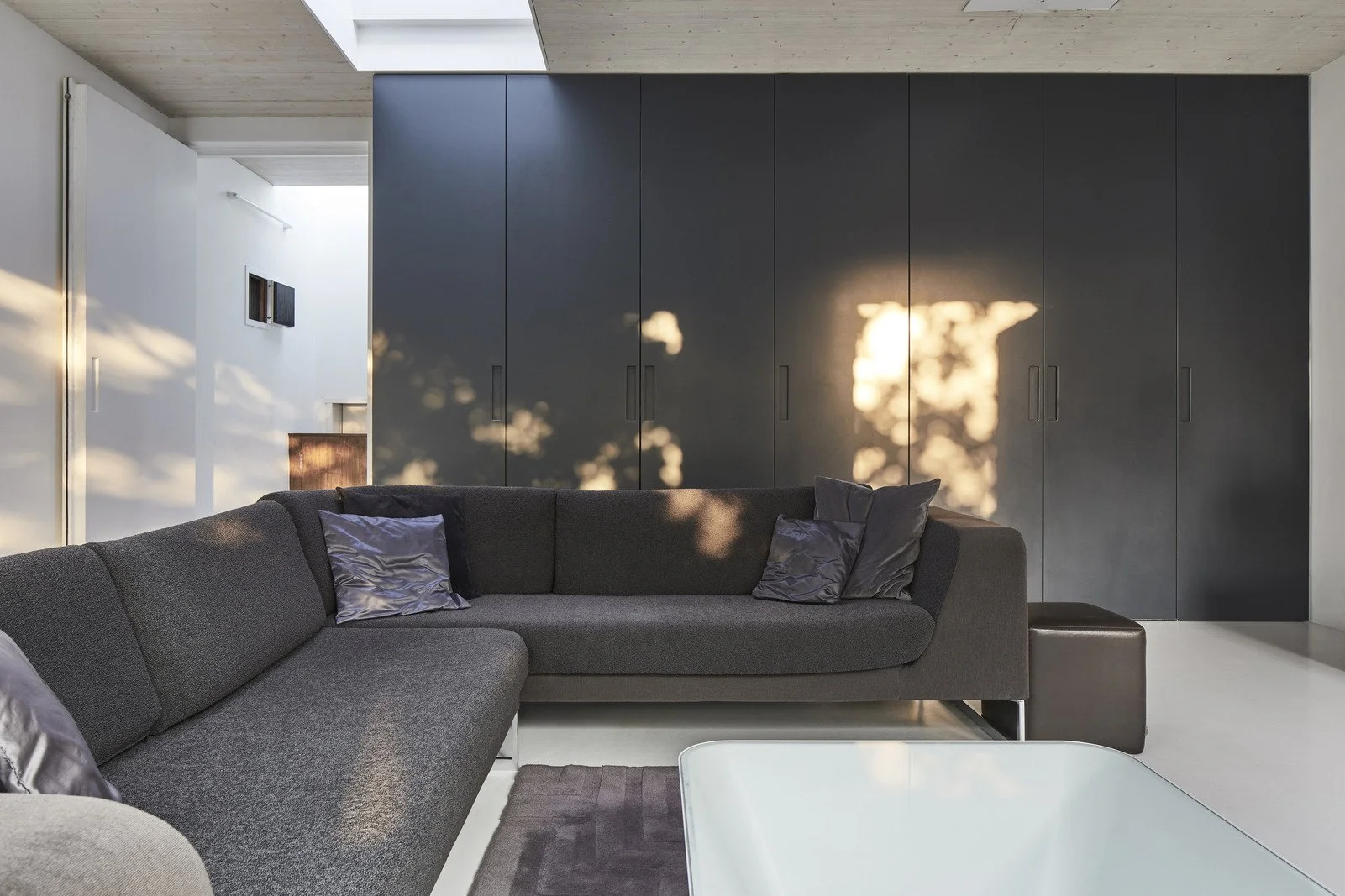 london-minimalist-timber-clad-modern-house-film-photo-shoot-location-unique-venue-hire-black-corner-sofa.jpg
