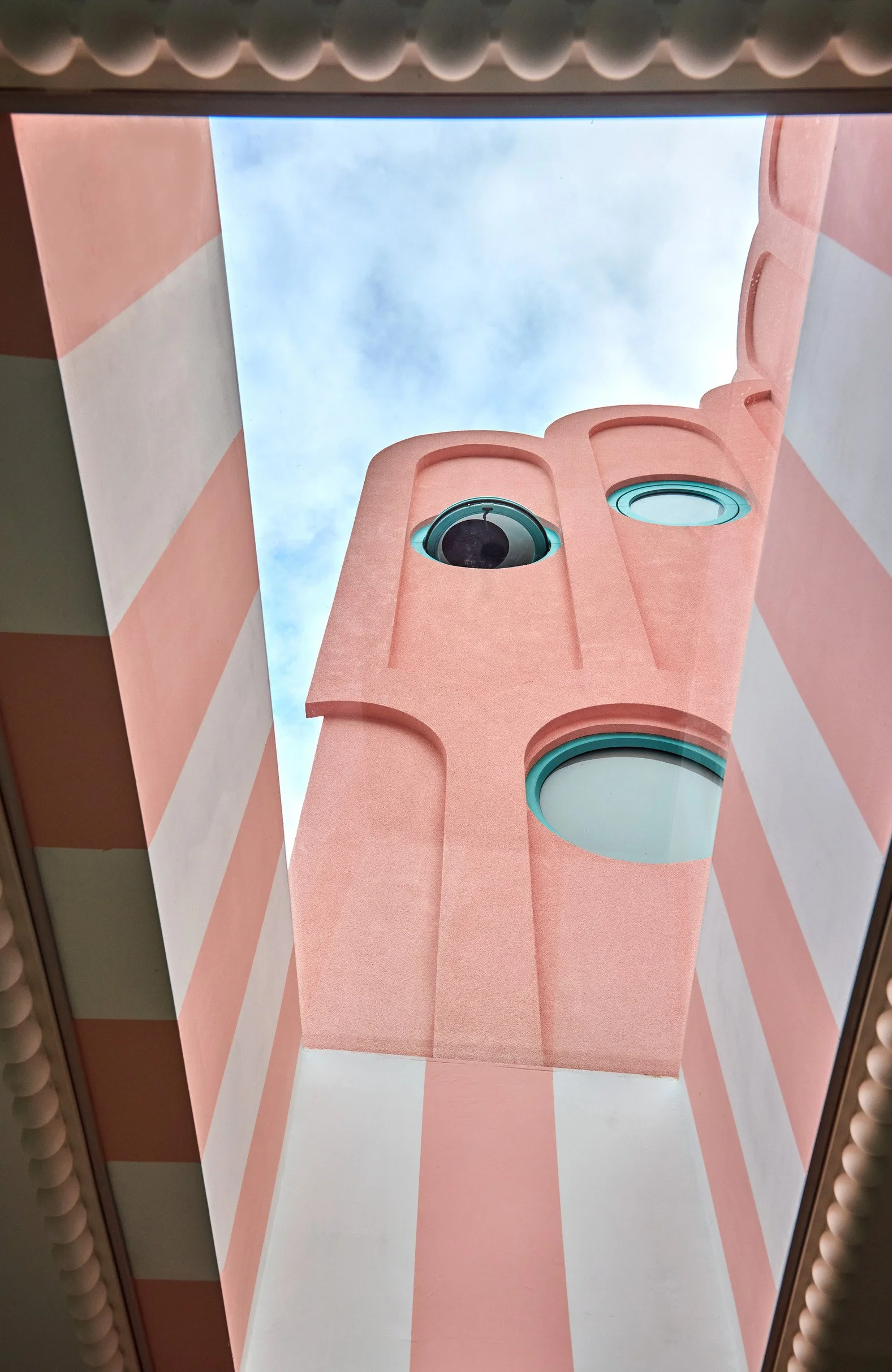 london-pink-wes-anderson-style-colourful-house-roof-terrace-filming-photoshoots-circular-window.jpg