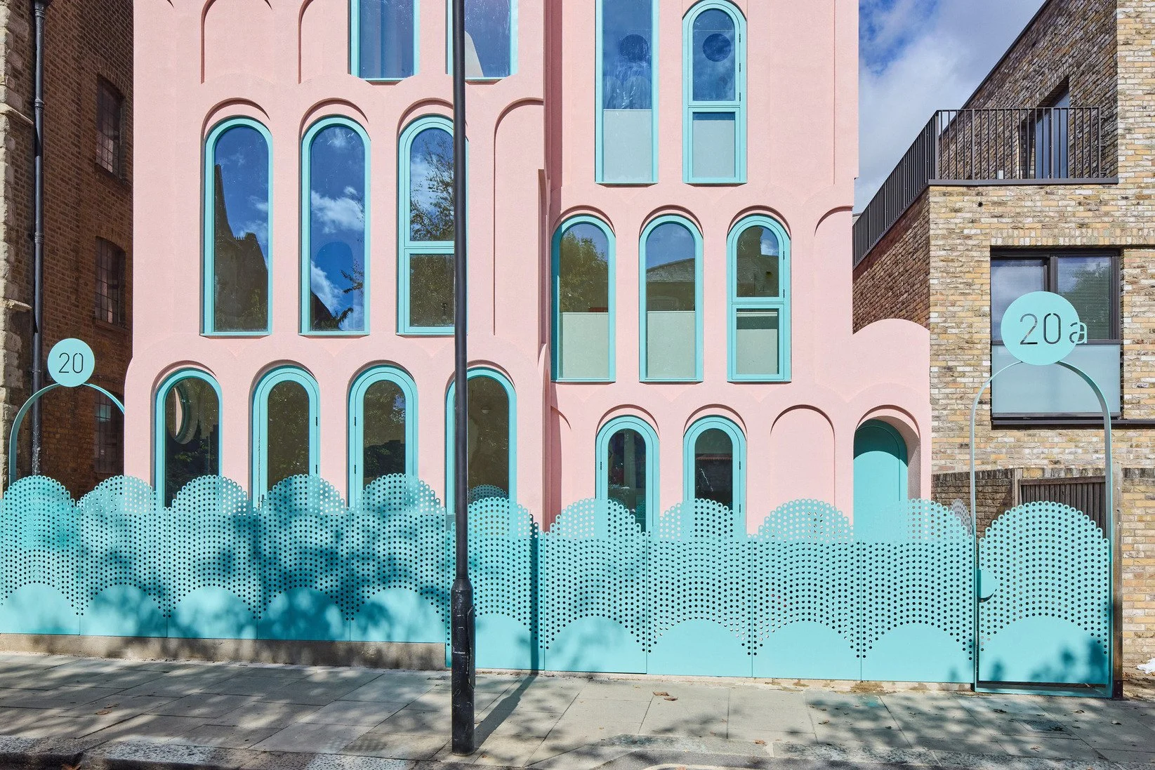 london-pink-wes-anderson-style-colourful-house-roof-terrace-filming-photoshoots-green-arched-fencing.jpg
