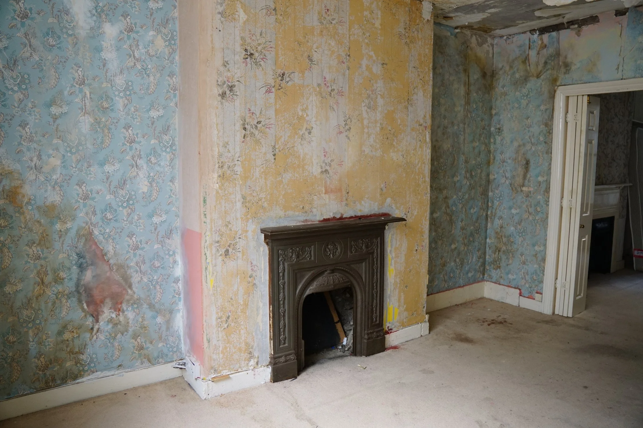 london-retro-distressed-white-stucco-terraced-house-unmodernised-filming-photoshoots-events-iron-fireplace.jpg