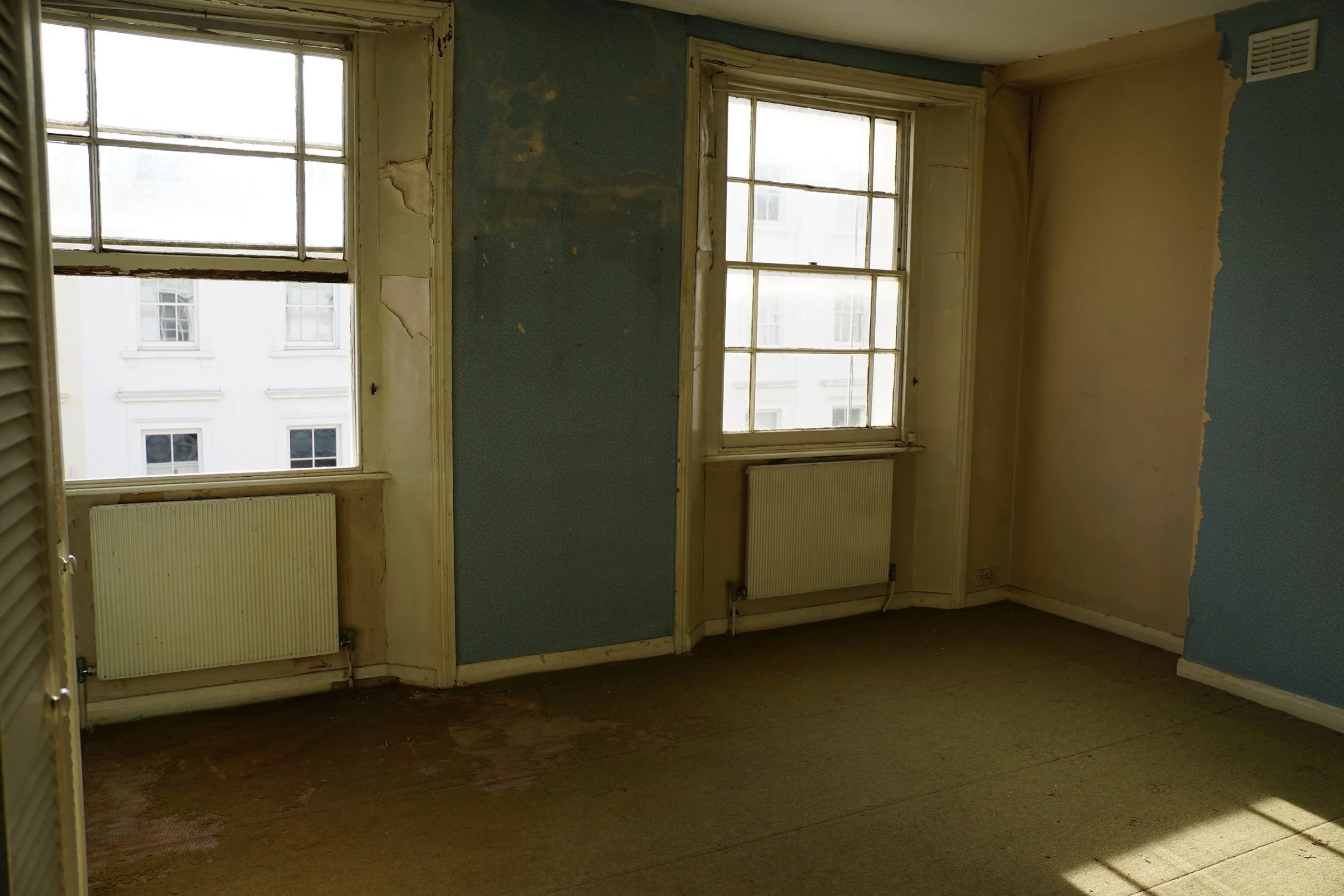 london-retro-distressed-white-stucco-terraced-house-unmodernised-filming-photoshoots-events-open-sash-windows.jpg