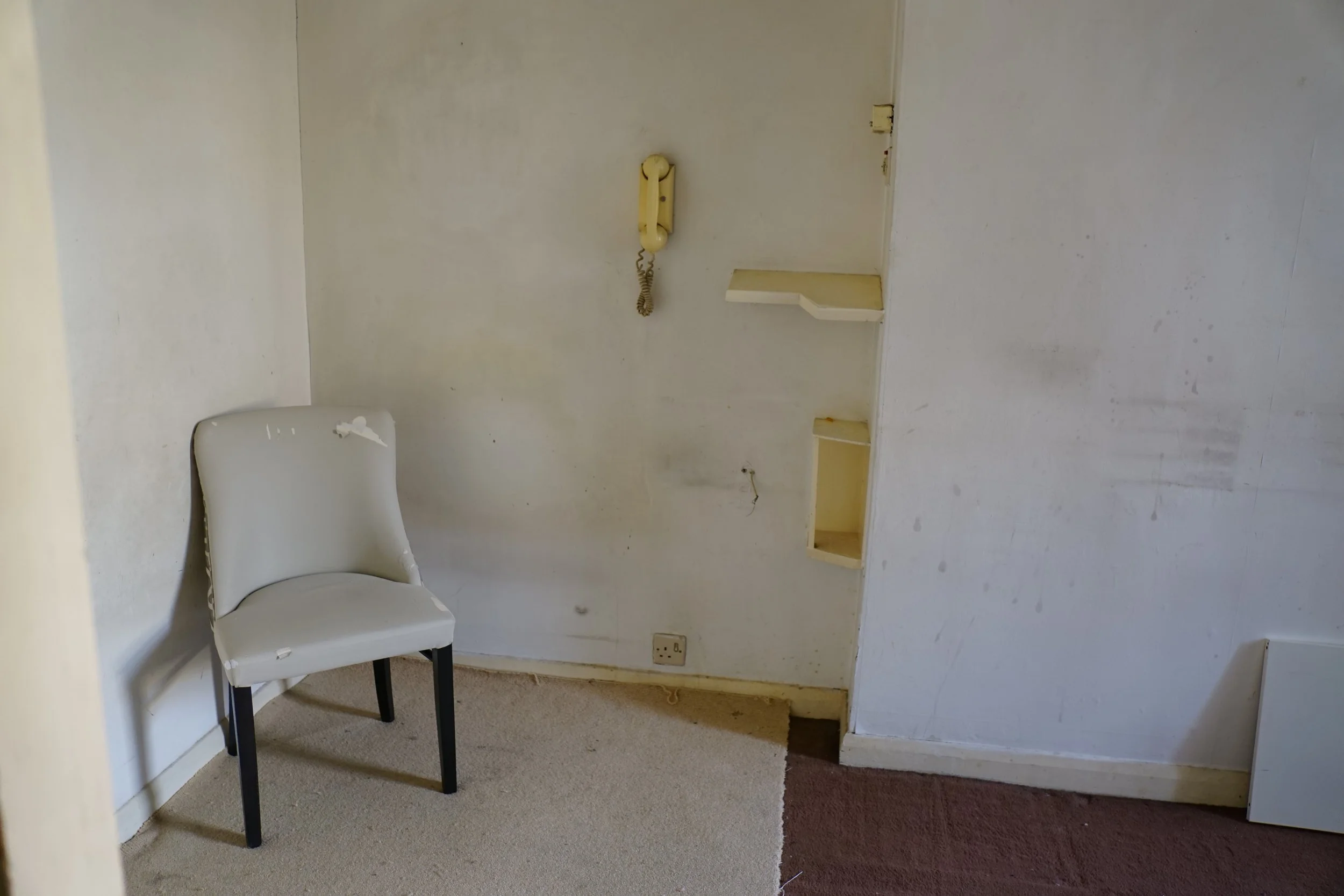 london-retro-distressed-white-stucco-terraced-house-unmodernised-filming-photoshoots-events-white-chair.jpg