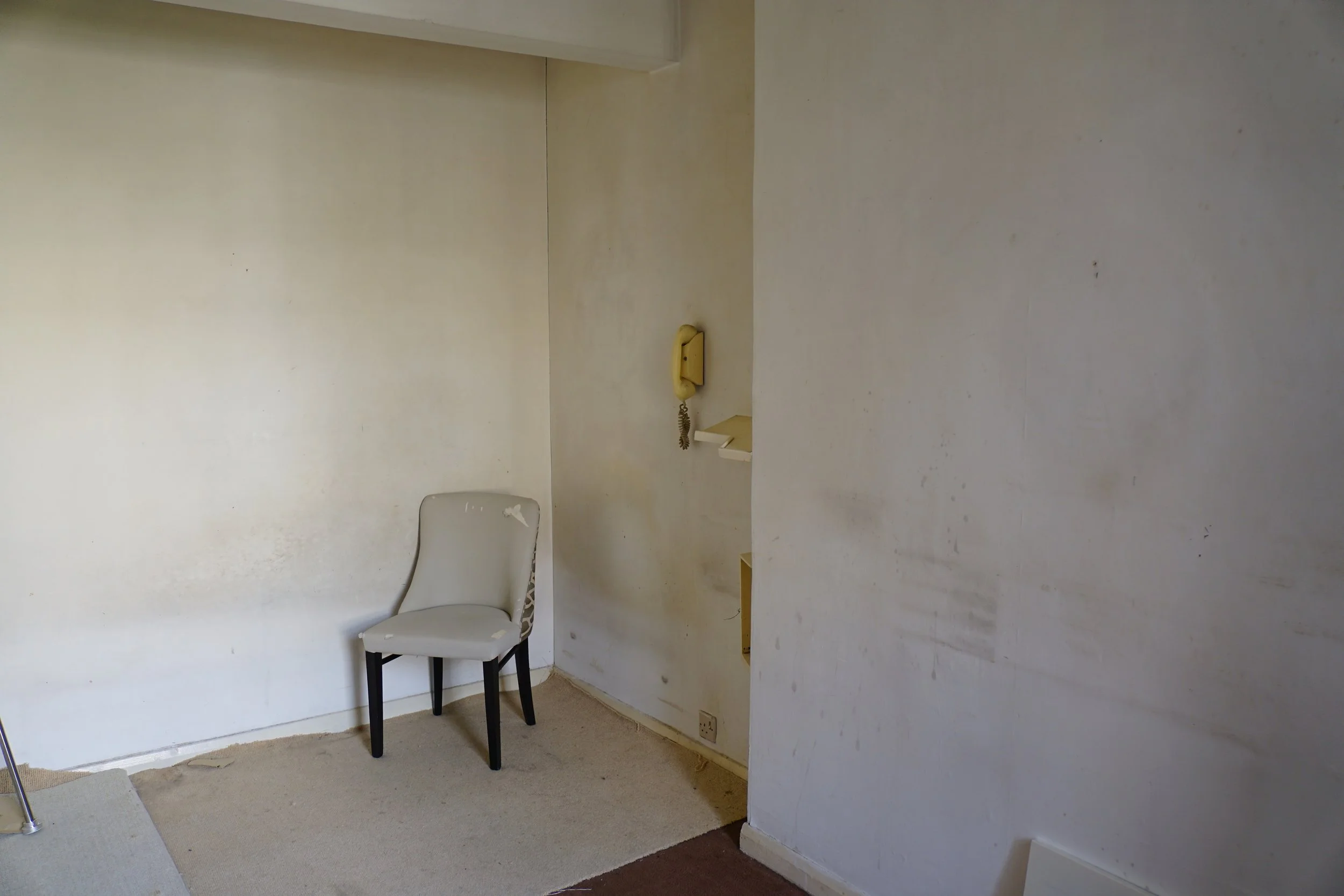 london-retro-distressed-white-stucco-terraced-house-unmodernised-filming-photoshoots-events-white-tub-chair.jpg