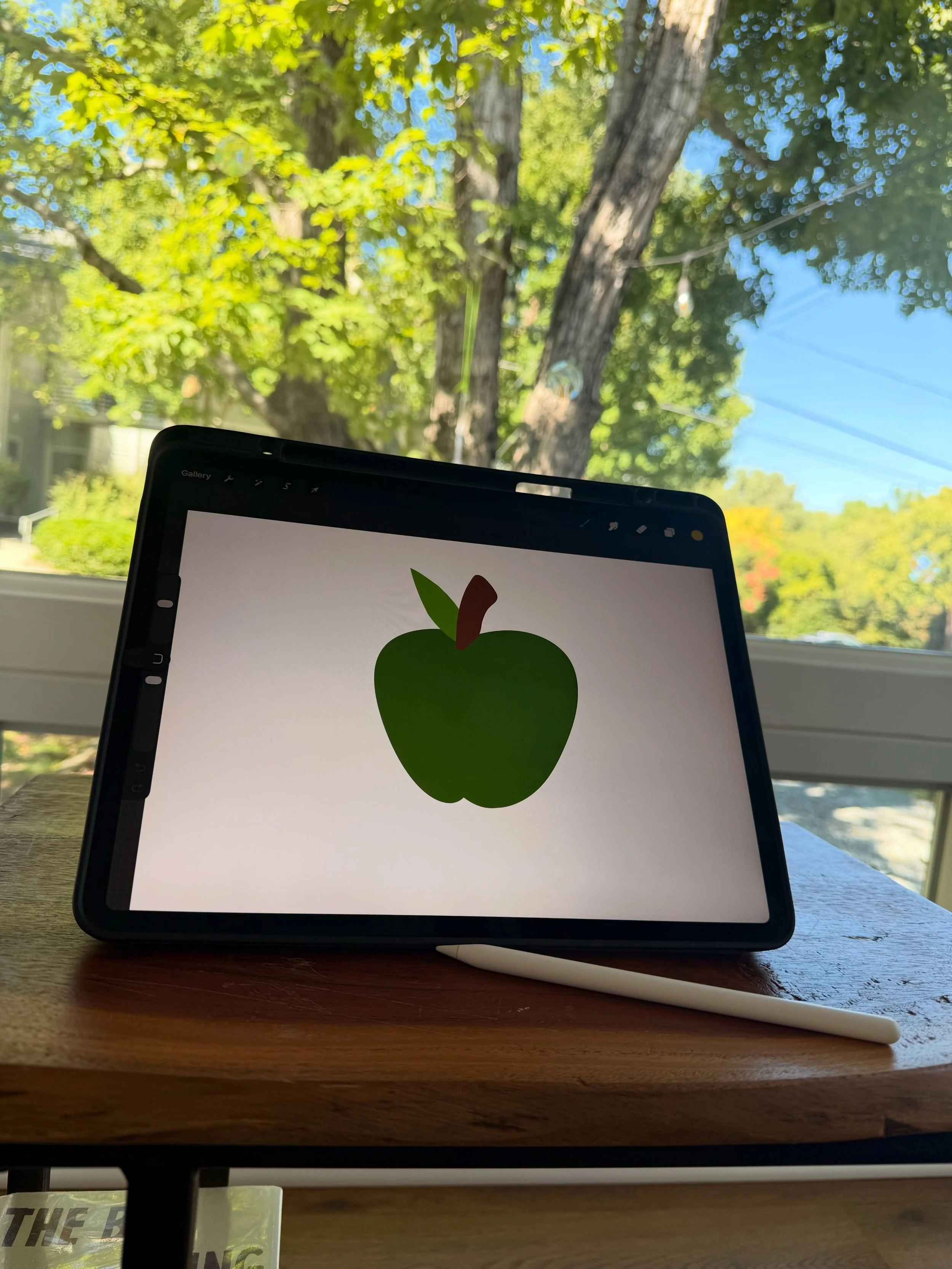 Fall yall! 🍎 

Working on some sweet site design elements for a new consulting biz. I&rsquo;m craving Macintosh apples for real rn. 

&bull;&bull;&bull;

Image description: photo of an iPad sitting on a small wooden table with a green apple drawn on