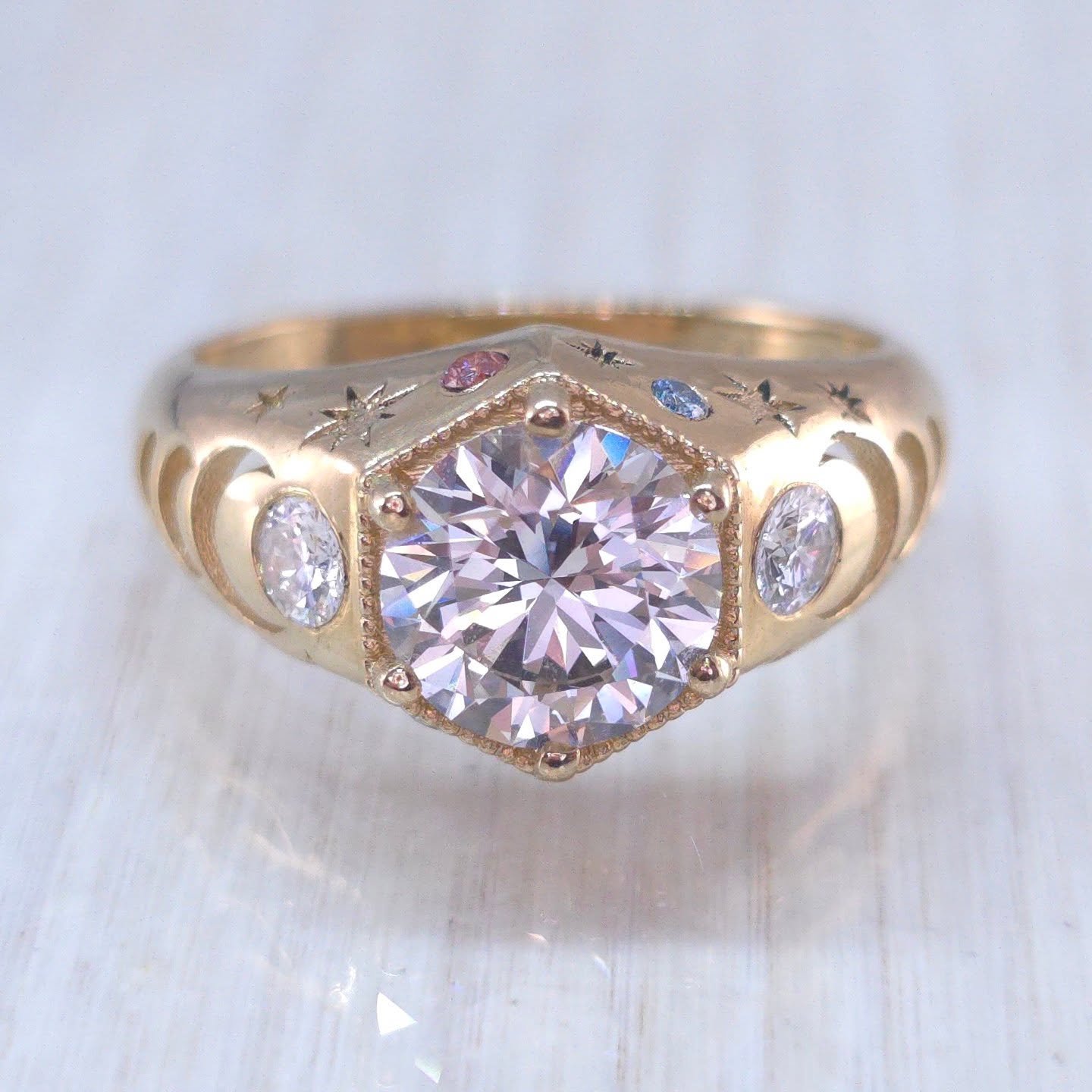 New design ✨ I created this 14kt solid yellow gold ring earlier last month and just wanted to share it again 🌙 A lab diamond is set in a milgrain hex setting with two side lab diamond accent stones with cascading moon phases. Flush set lab diamonds 