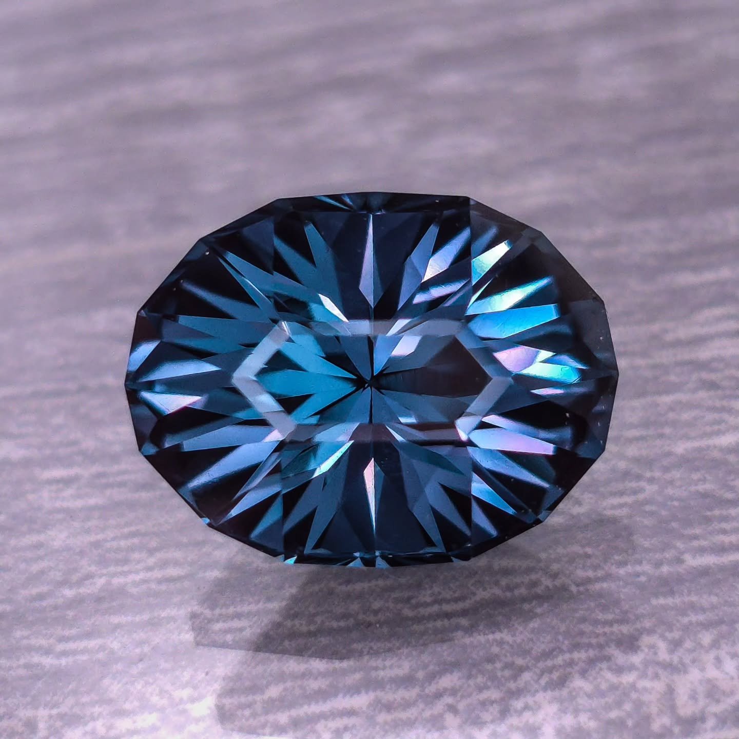 Available 🩵 www.ThePacificLights.com - This very large 14mm x 10.5mm Djeva brand Spinel is up for grabs! This is a Tesoro design from his book that I absolutely love cutting, especially for large stones. This is the only true teal color available th