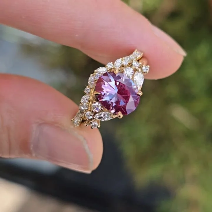 Available ✨ 9mm Czochralski Alexandrite cut by me in the design Omni Oval - sits in 14kt yellow gold surrounded by a cluster of lab diamond marquis and rounds. Comes with matching wedding band of alternating marquis and rounds for a delightful floral