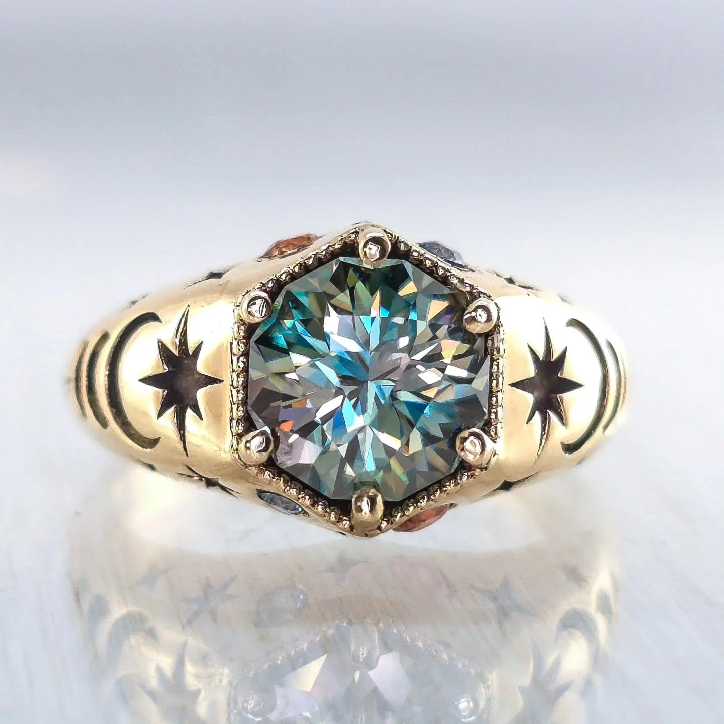 One of my favorite designs for a client - the Moon Phase Cut Out ring is fully customizable with personalized color accent stones, moon and star embossing elements, and star cut out details underneath. My client chose dichroic Moissanite to match the