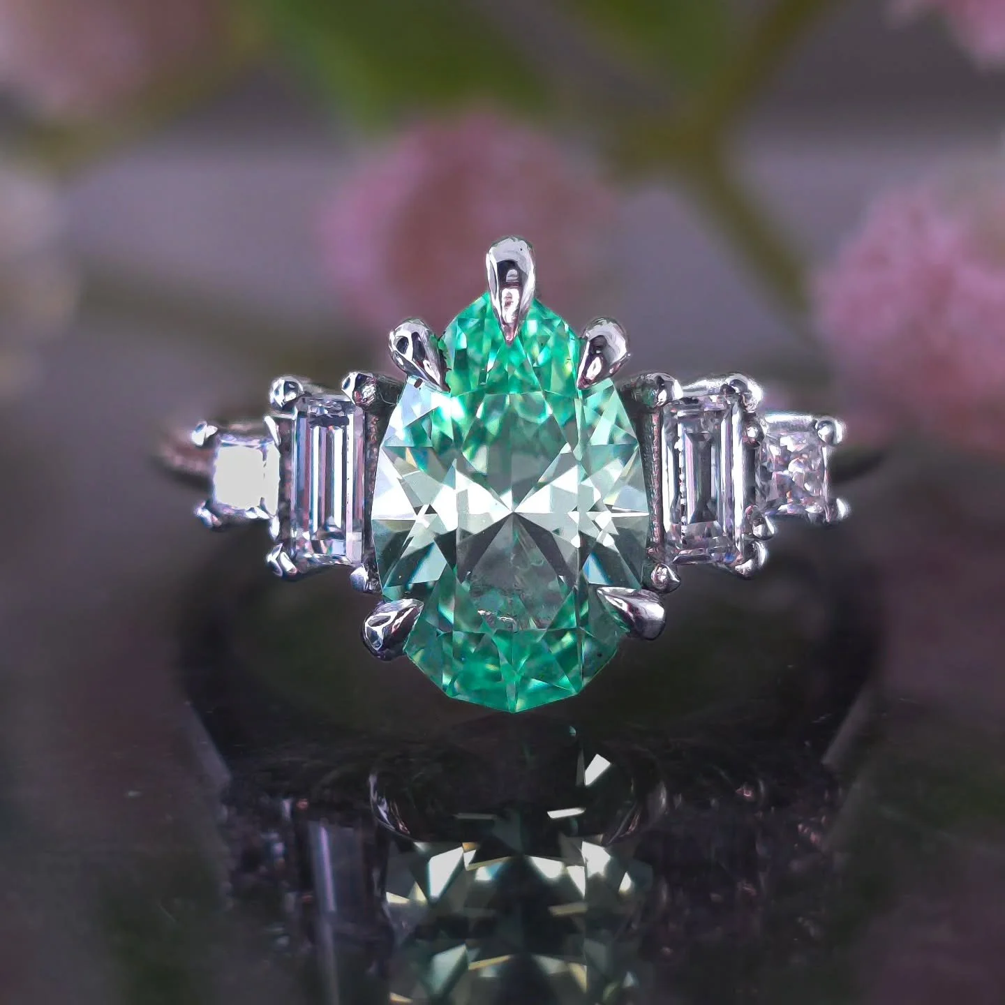 New Commission ✨ This bespoke platinum ring was inspired by a client's incredible vision. We crafted a 10mm custom seafoam lab sapphire pear, surrounded by baguette and princess cut lab diamonds. The swooping cathedral setting adds a touch of eleganc