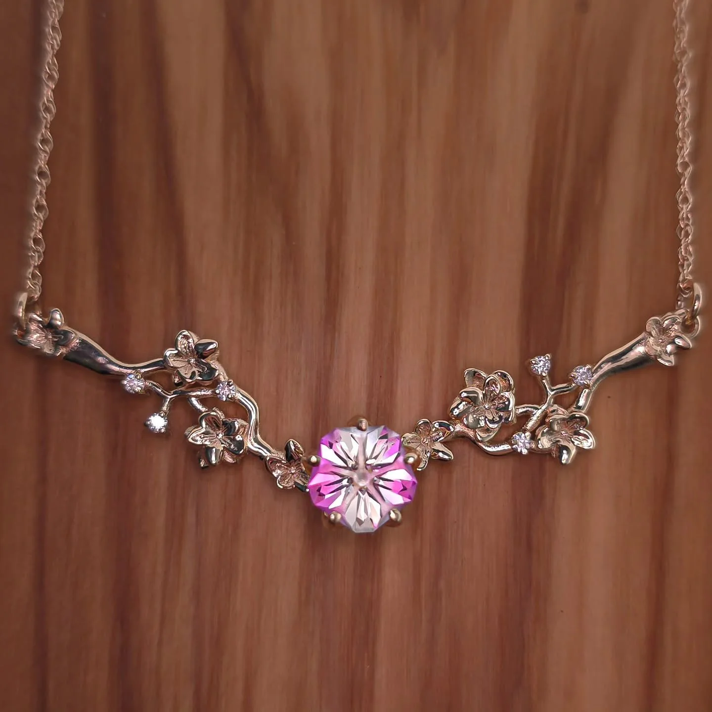 I'm thrilled to share that this exquisite 14kt solid gold necklace, part of my Flora Collection, is available for order. You can choose your gemstone, but the Hanami design is a popular choice! This delicate piece features cherry blossoms and Lab Dia