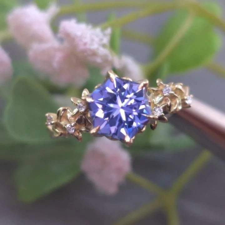 ✨I finished this delightful commission for a new couple and had to share with you guys. Solid 18kt yellow gold with a custom cut Lab sapphire. Jasmine flowers sit nestled with leaves and vines with lab diamond accents, sitting alongside a custom peta