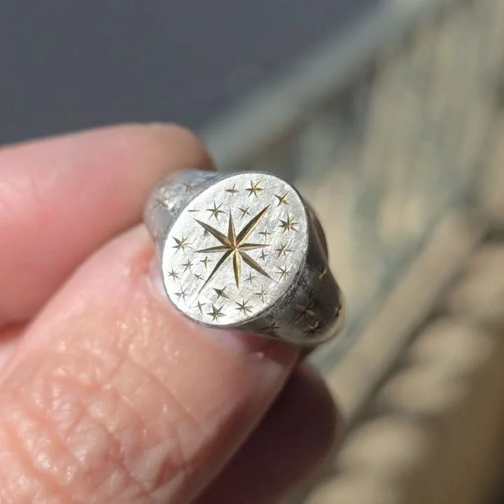 Available ✨ I present another ethereal silver signet ring with hand engraved stars. This one is size 6.75 with a matte finish and oxidized details. Star symbol underneath, light weight and affordable. These engraved rings are one if a kind and no two