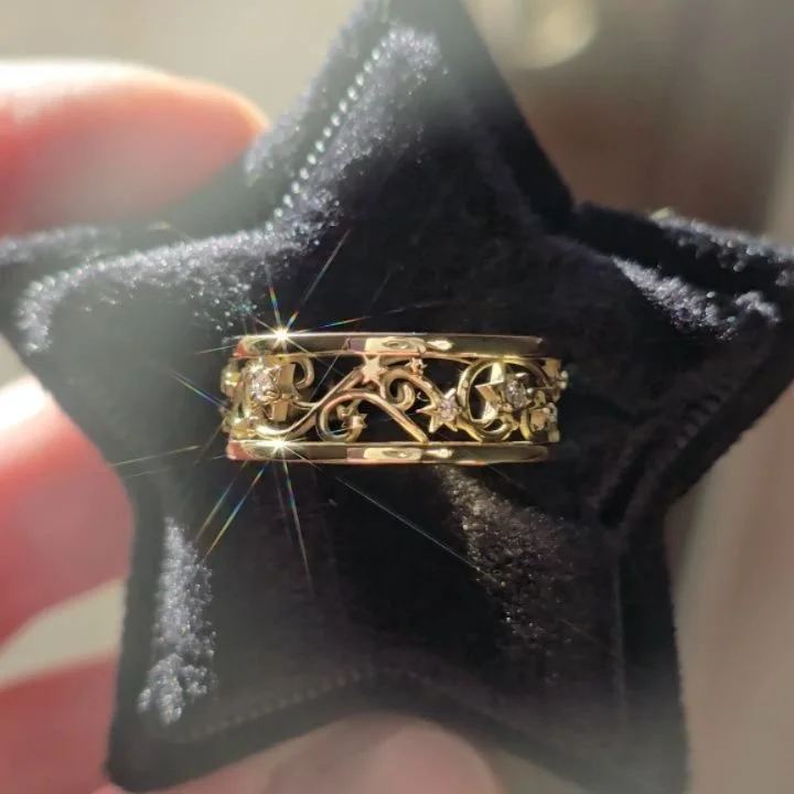 ✨This is an older design, but I get so excited when someone orders it! This beautiful piece is in 18kt gold and part of my Celestial Collection. Swirls of filigree whisps carry multiple types of stars with lab diamond accents, tumbling around the ban