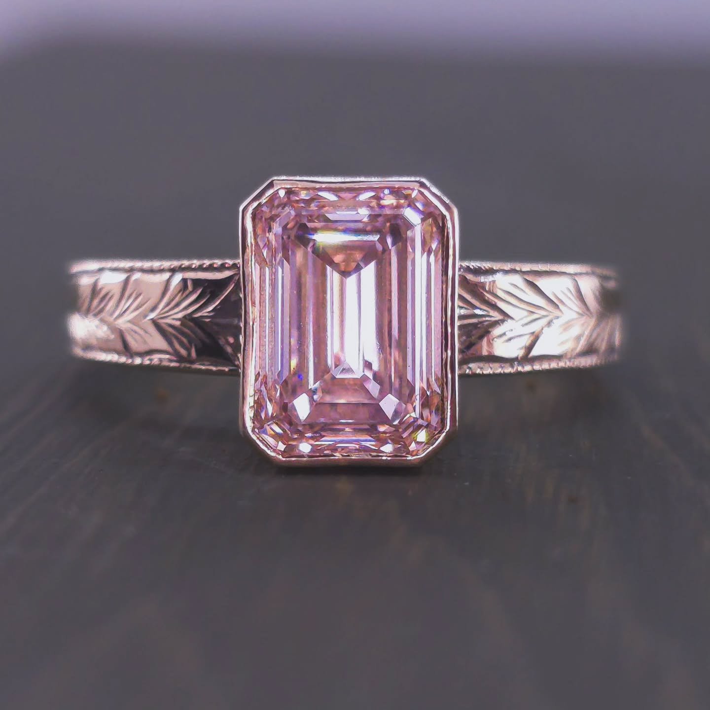 New arrival alert! This hand-engraved gold ring showcases a breathtaking Lab diamond, emerald cut, roughly available with ~2-2.1 ct VVS1 diamonds in Fancy Pink or White. Natural diamonds are also available.The intricate leaf design and open bezel set