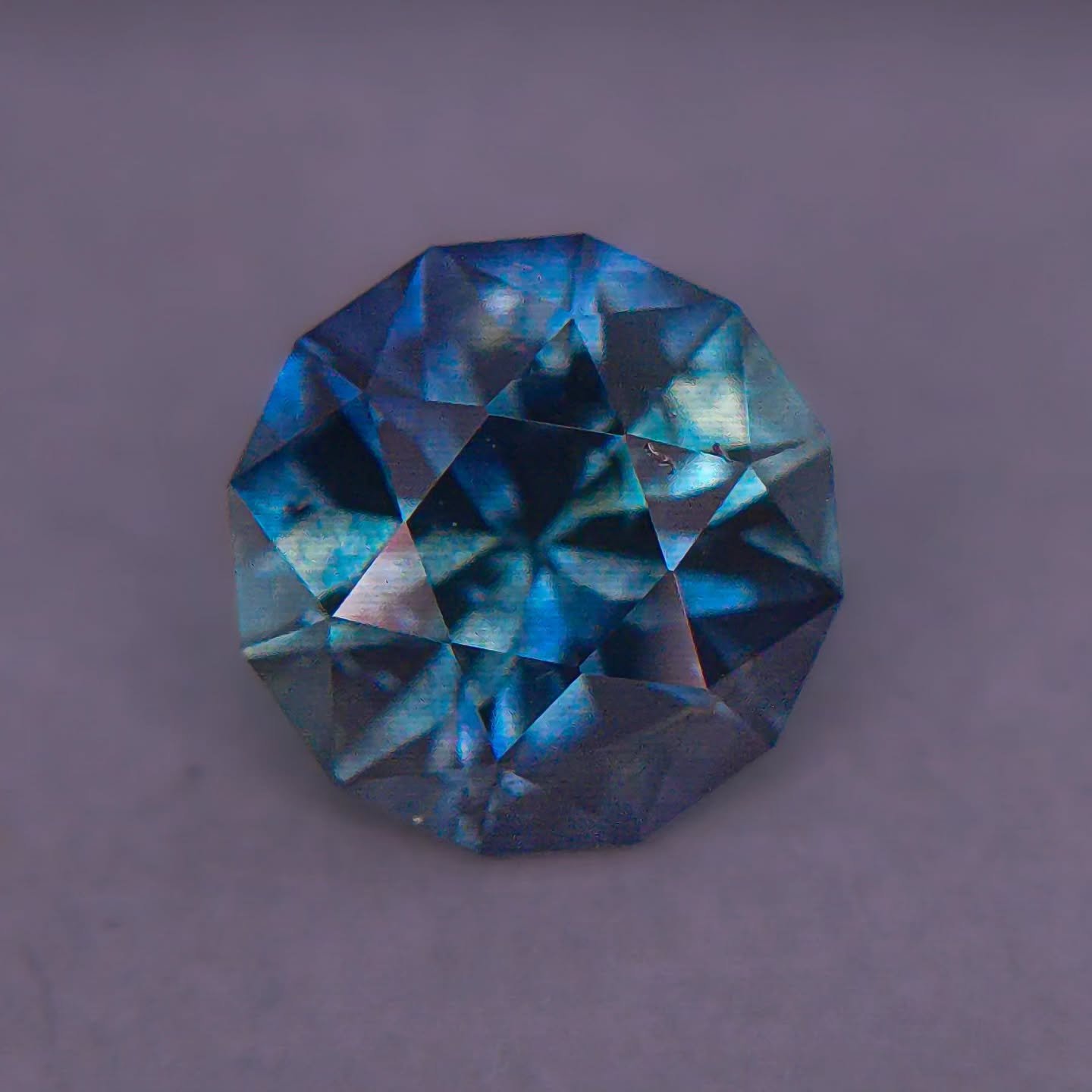 Available 🎇 1.77ct ~8mm Natural Montana Sapphire - Heated - cut in Scott Labories design Titan. Stunning color on this stone and a fantastic size! Teal Blue with some greener zoning in the center. One silky inclusion in the side (does not obstruct c