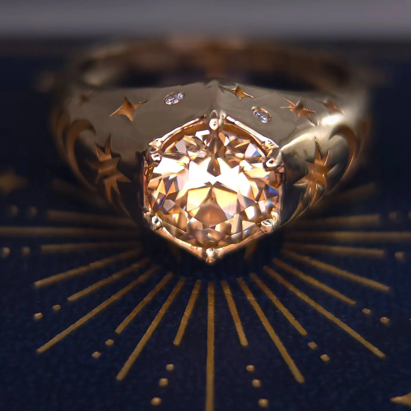 This ring is always available as part of my Celestial Collection. This particular client order features a champagne Moissanite, cut by me in Scott Labories design Titan. 8mm set in 14kt solid yellow gold with cut out moon phases, stars and flush set 