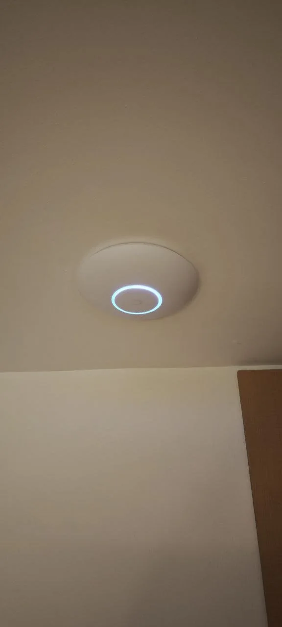 Ceiling light with a circular design and a blue glow in the room.