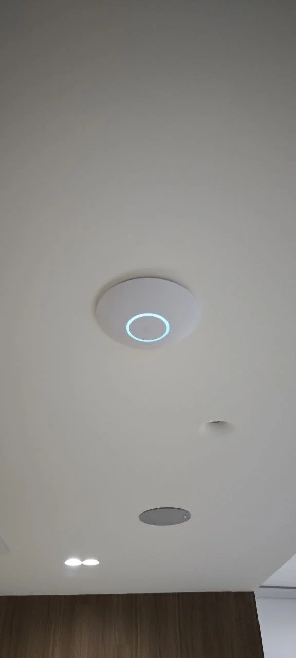 Ceiling with multiple built-in speakers and lights, including a circular design with a blue LED ring.