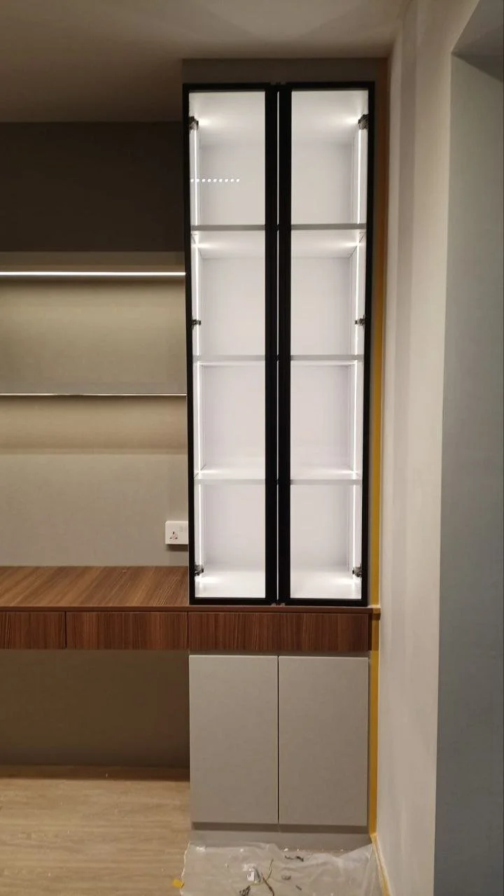 Empty glass display cabinet with glass shelves, mounted on a wall in a modern room.