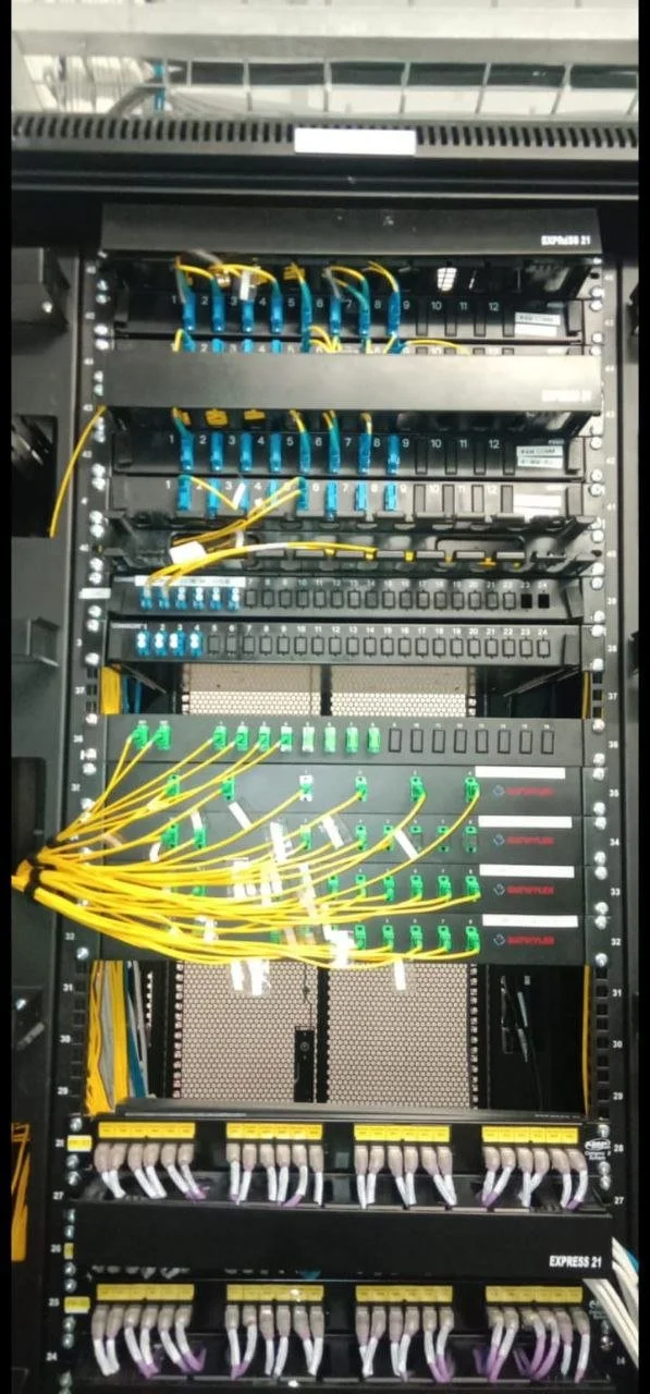 A network server rack with various network cables and switches connected.