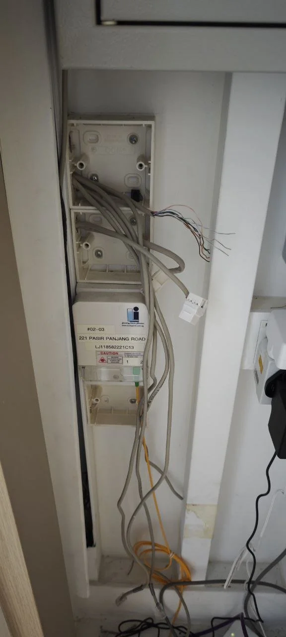 Open electrical box with multiple loose wires inside the wall.
