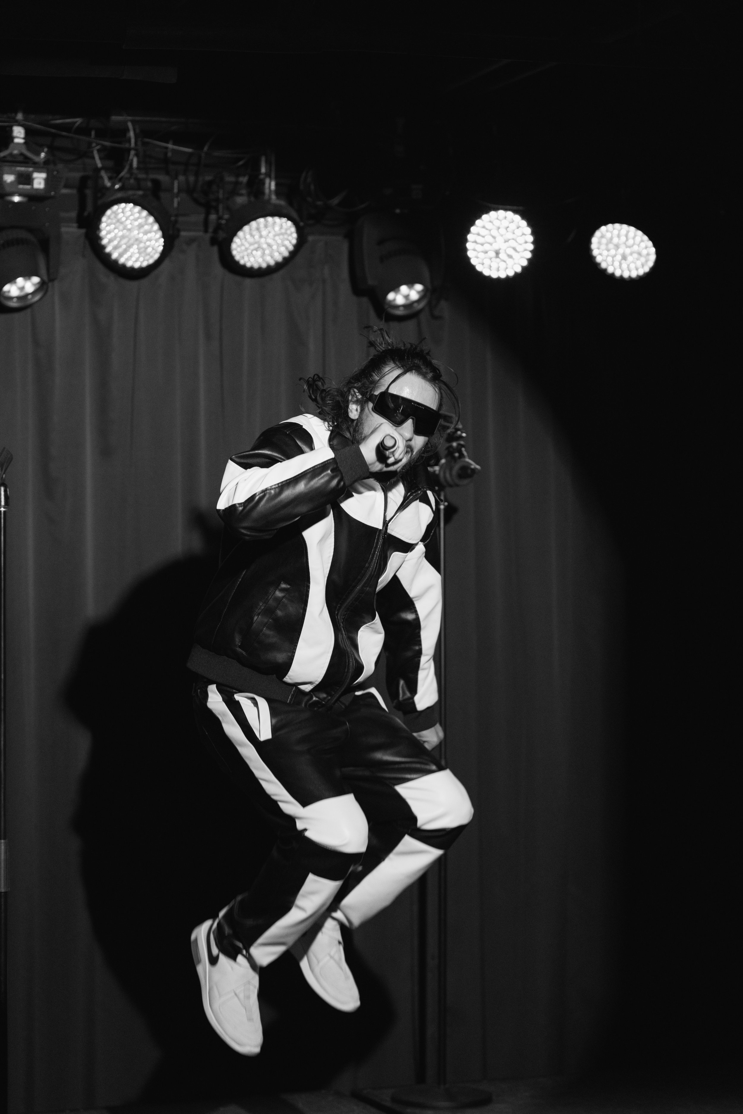 photo of music artist jumping up during live concert in green bay wisconsin