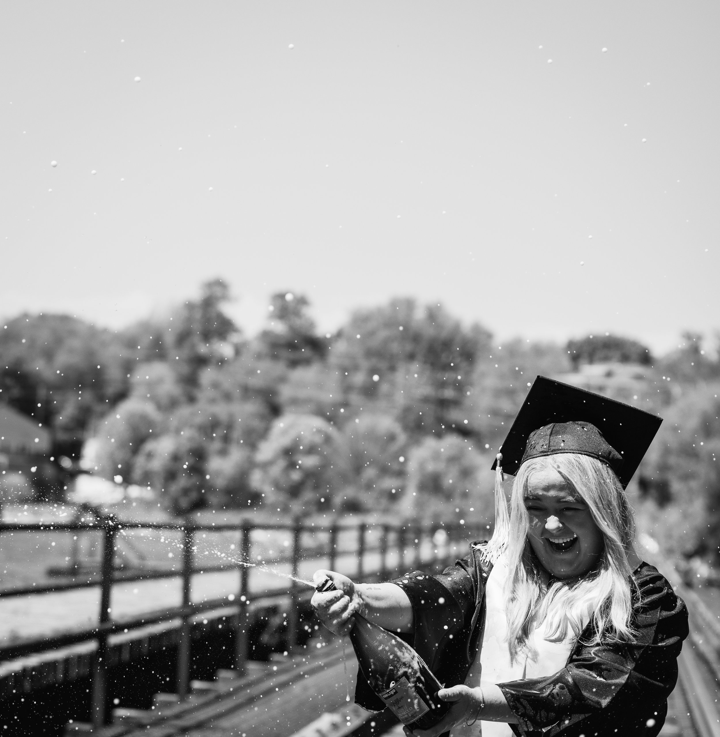 photo of college grad celebrating with a champagne bottle in appleton wisconsin