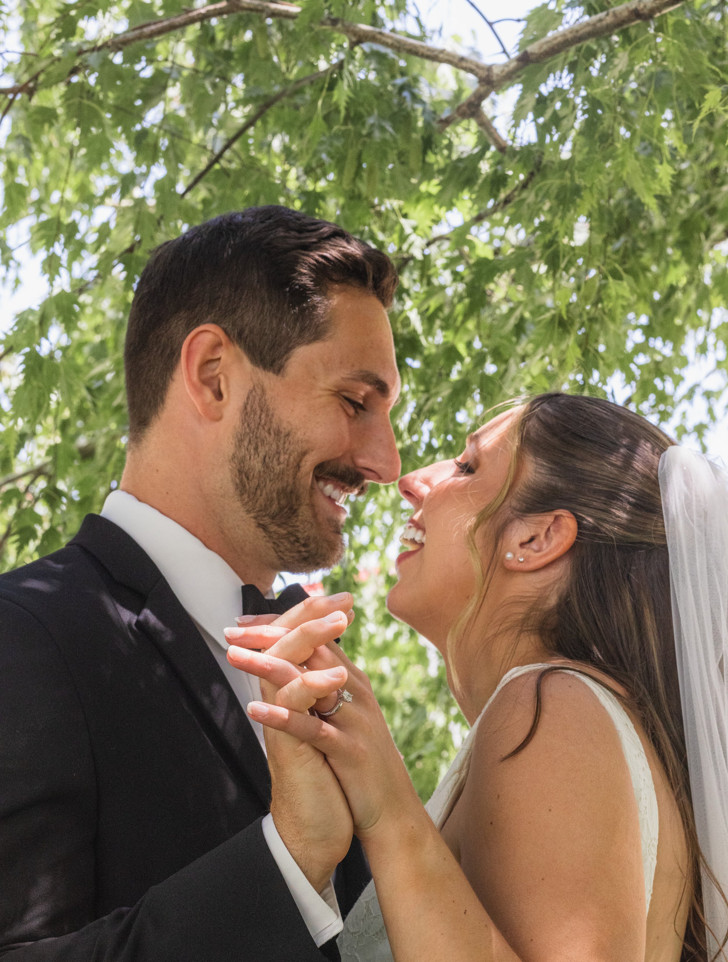 cute wedding photo of couple under a tree after getting married in oshkosh wisconsin