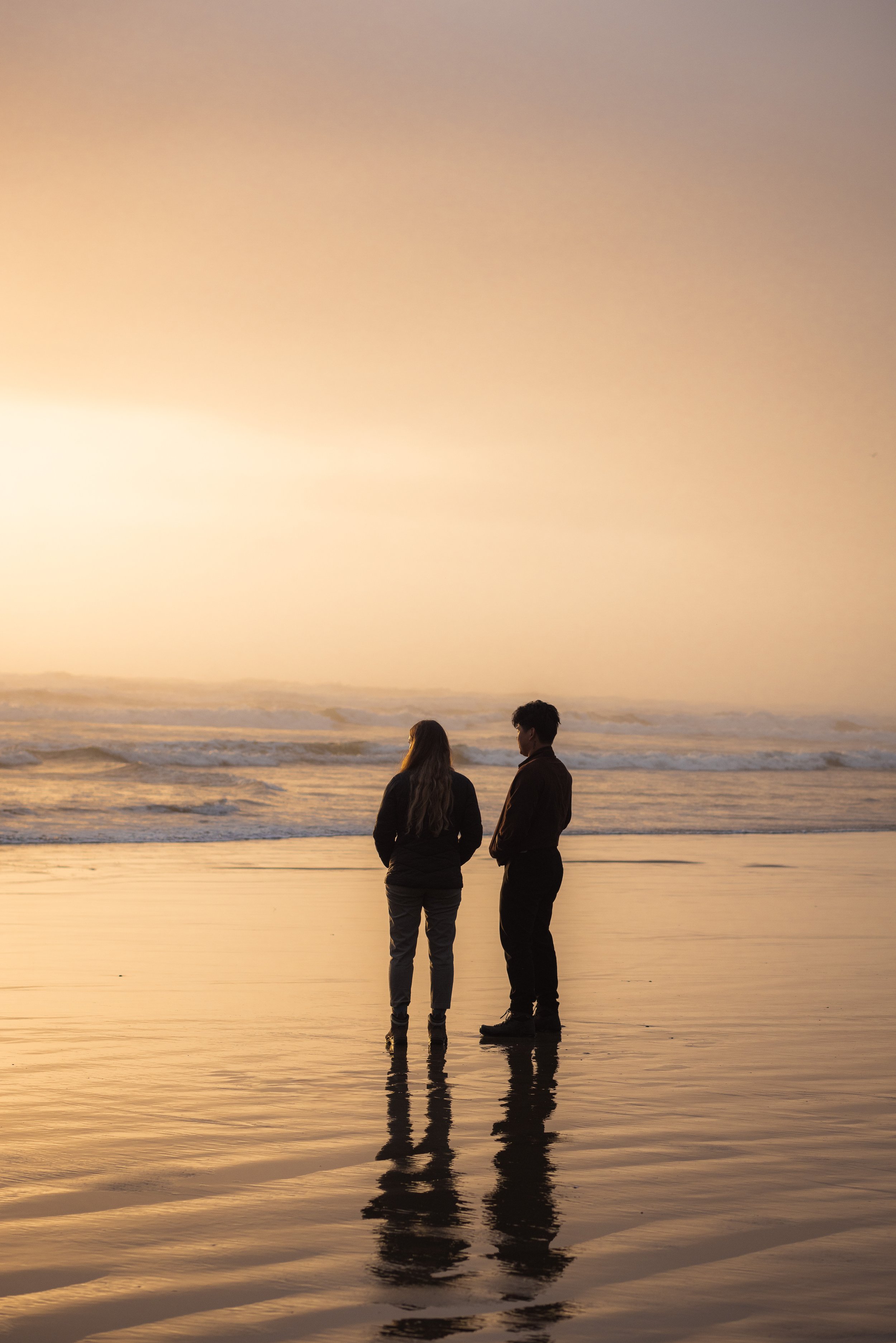 picture of two people at the beach during sunset in cannon beach, oregon